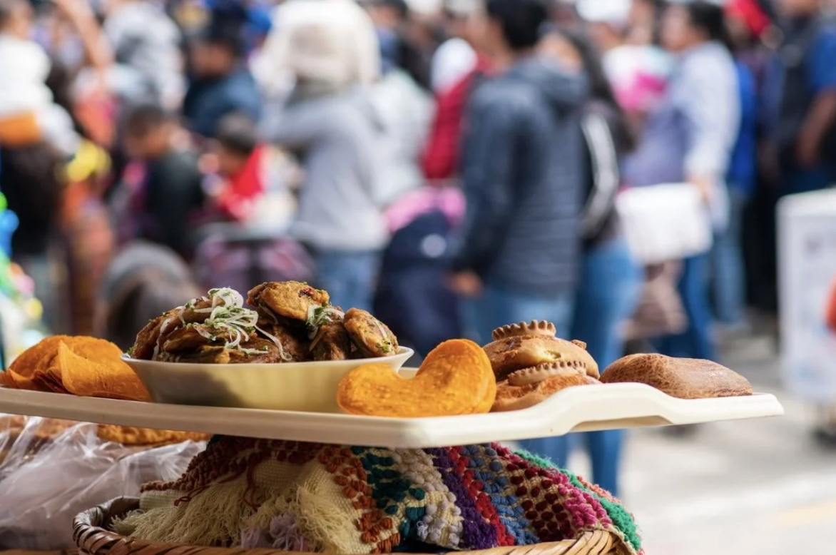 A plate displays different types of Guatemalan street foods at a festival