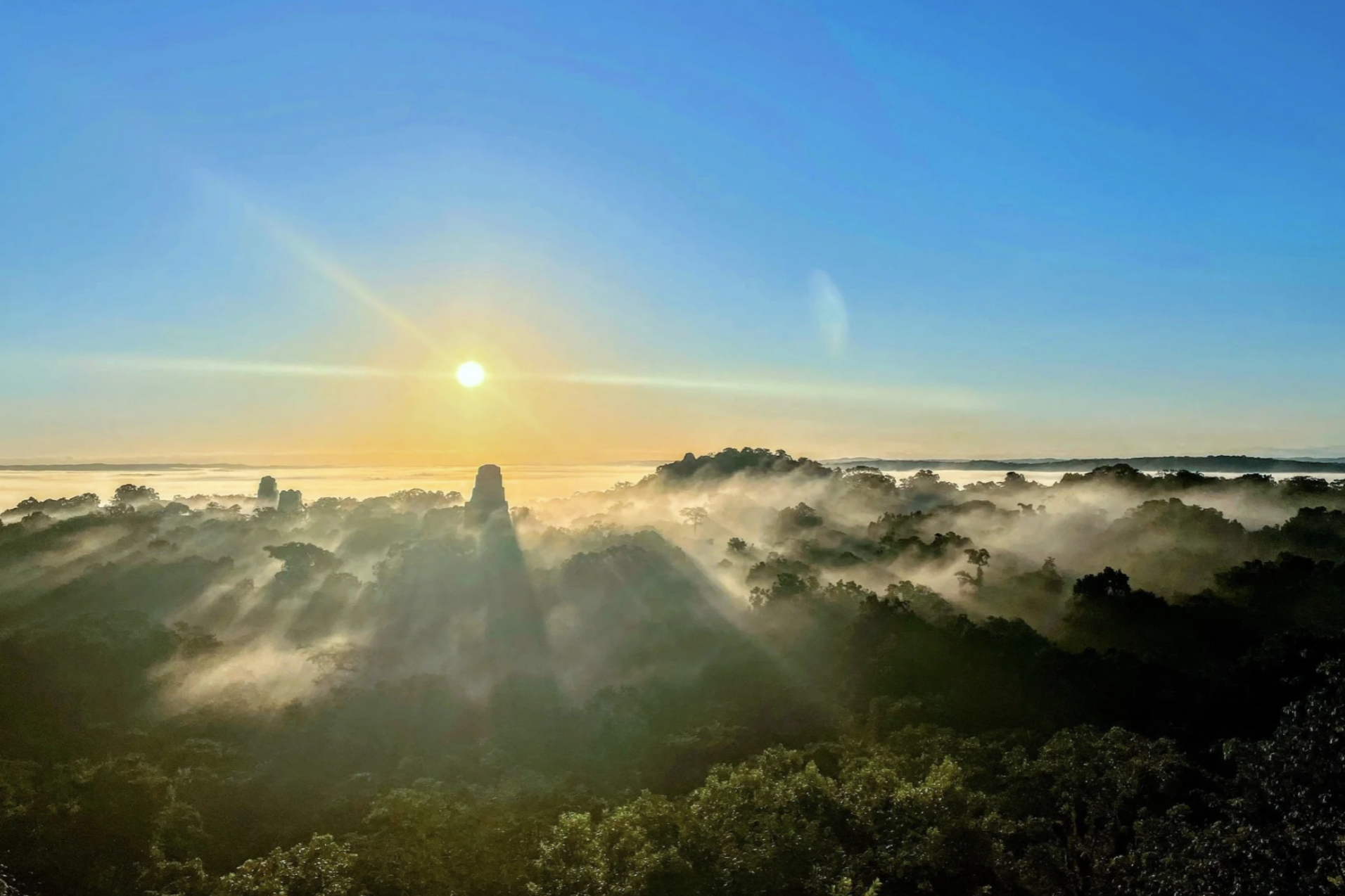 A beautiful photo of the sunrising above fog and clouds in the early morning at the Peten region in Guatemala.