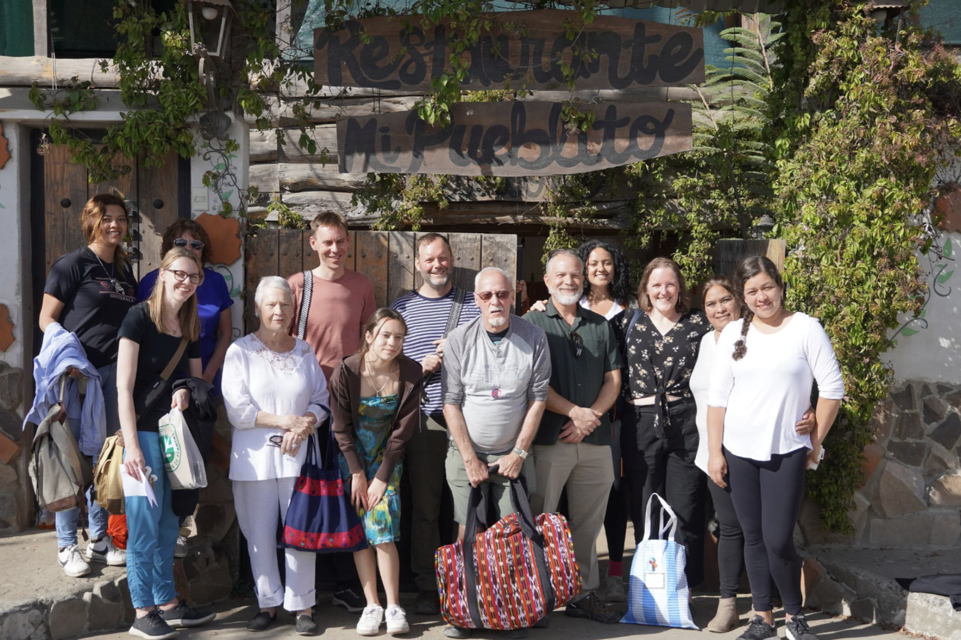 A group stands in front of a restaurant in Guatemala during international student tours