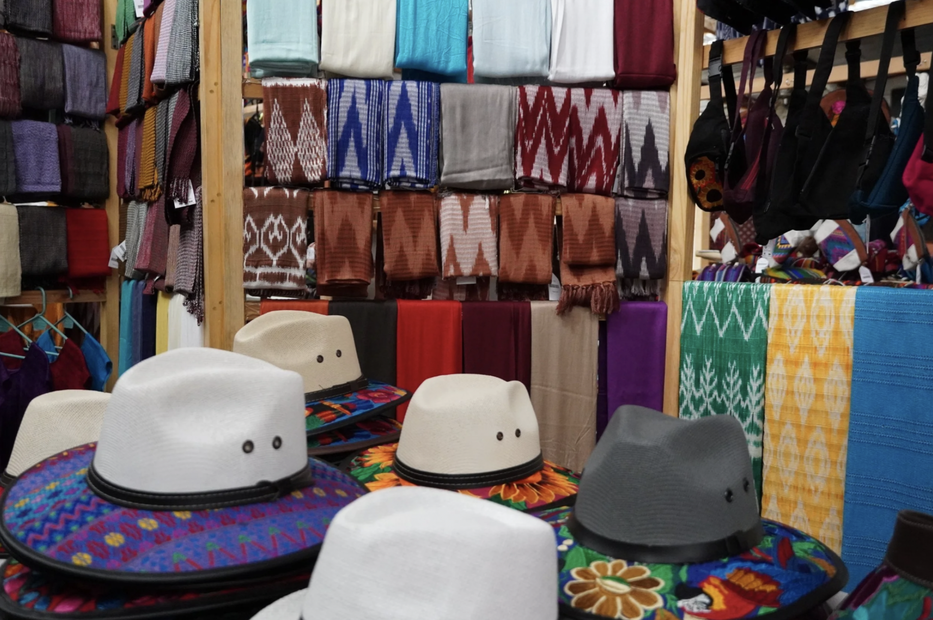 Handmade textile products are for sale in a shop in Lake Atitlan, there are hats, bags, shirts, scarfs, and more.