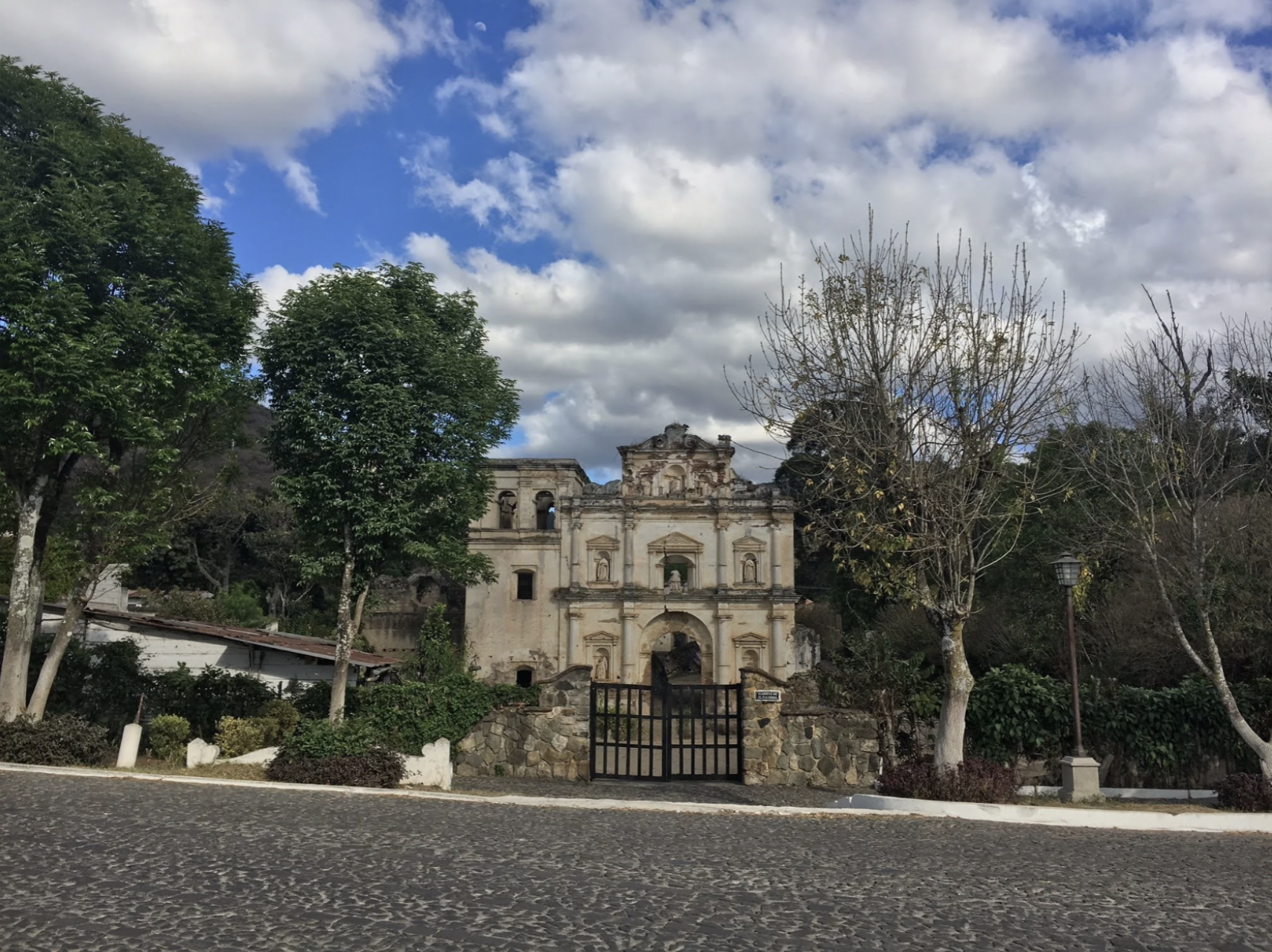 A church behind a black gate on the road in Antigua Guatemala