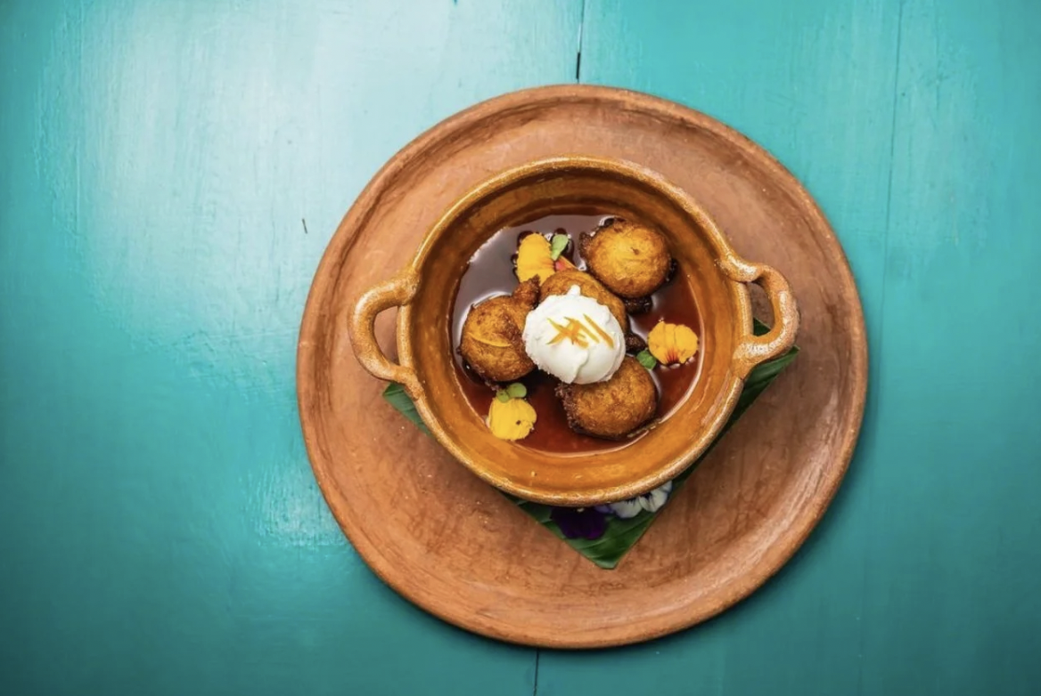 A picture of a desert with vanilla ice cream on a turquoise colored table from Maxan Restaurant in Antigua.