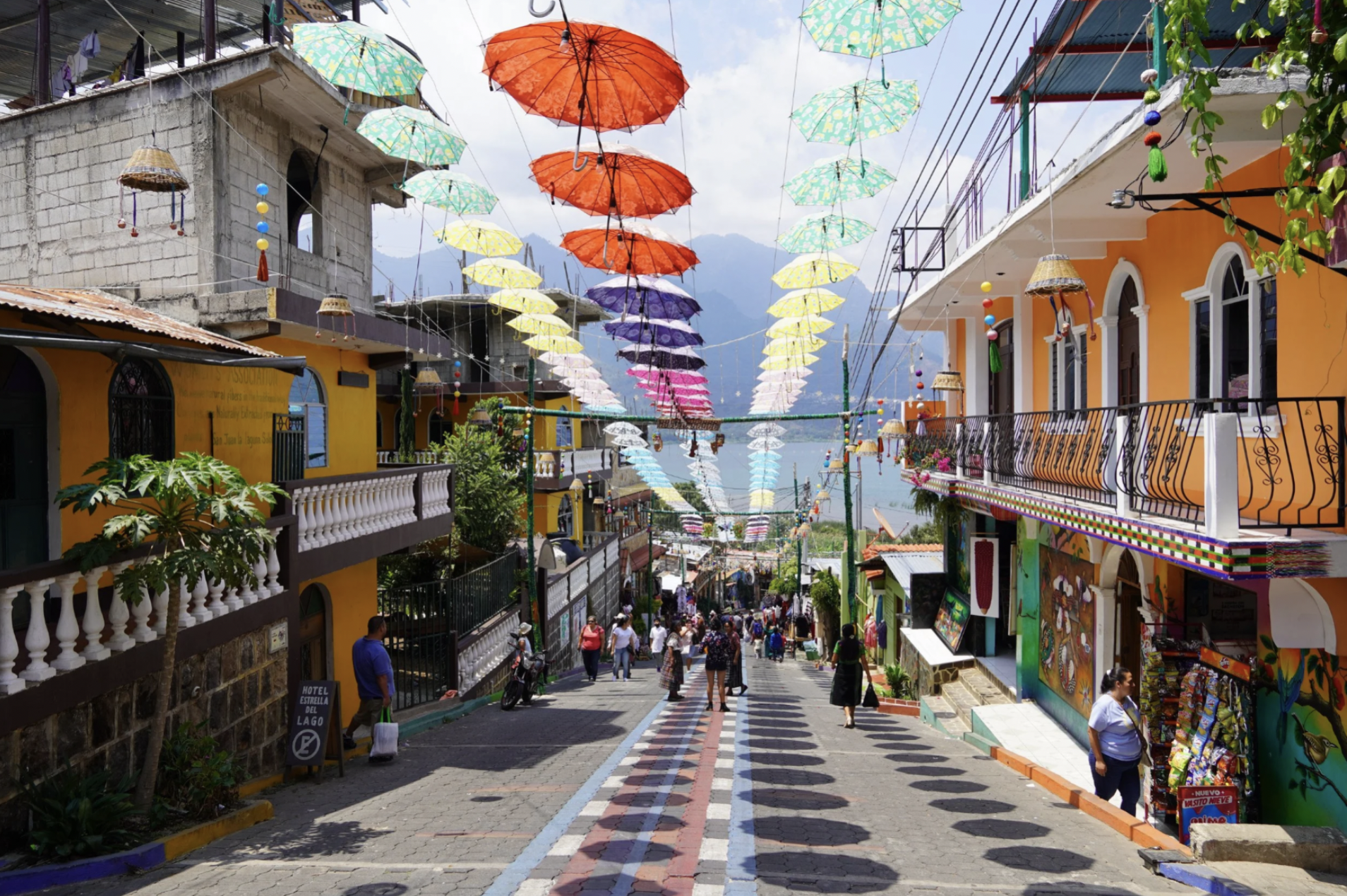 A vibrant road with umbrellas hanging between the buildings in Lake Atitlan, part of the Guatemalan Highlands