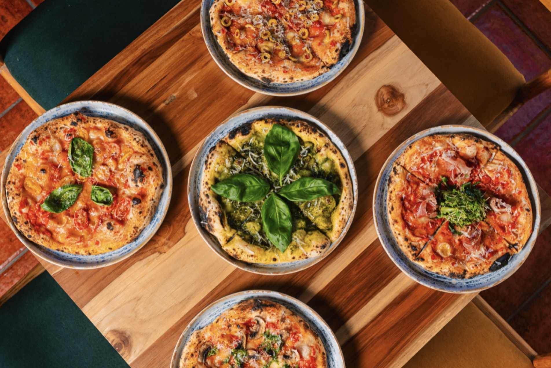 Five different types of pizza are on the table at Franca, one of the the best restaurants in Antigua Guatemala