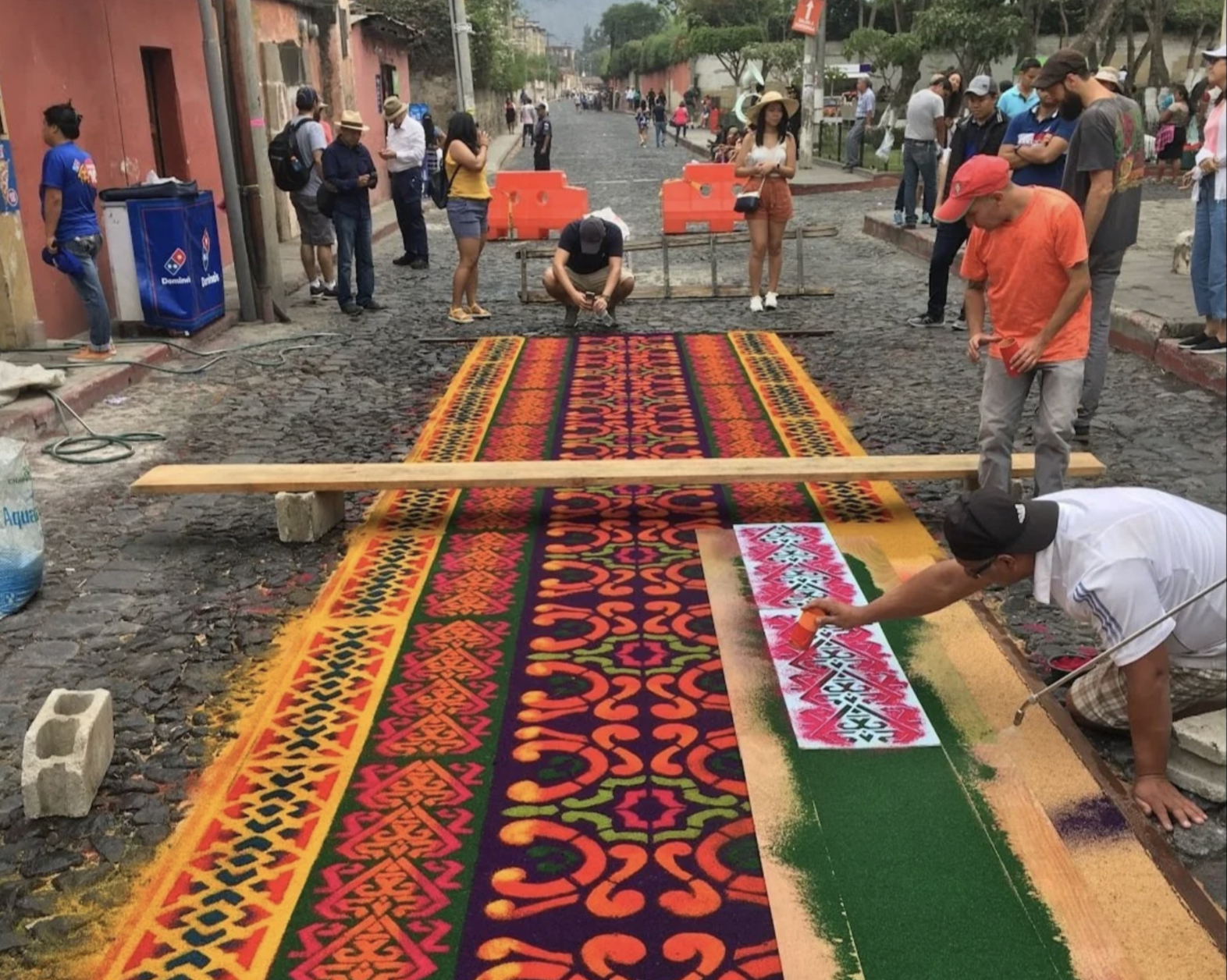 People are working together in the street to create the vibrant carpets for Semana Santa in Guatemala