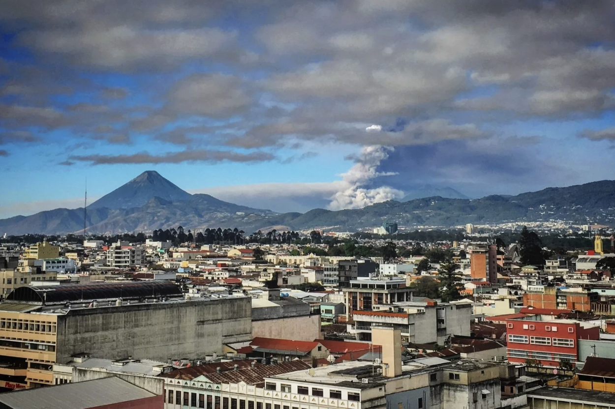 A photo of the smoke and ash rising from the volcano just beyond the view of Guatemala City