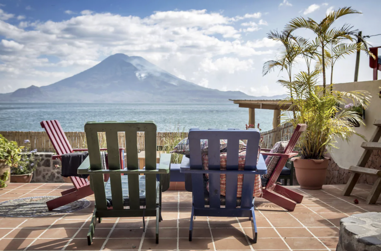 Two chairs are looking out at Lake Atitlan at the La Iguana Perdida hotel