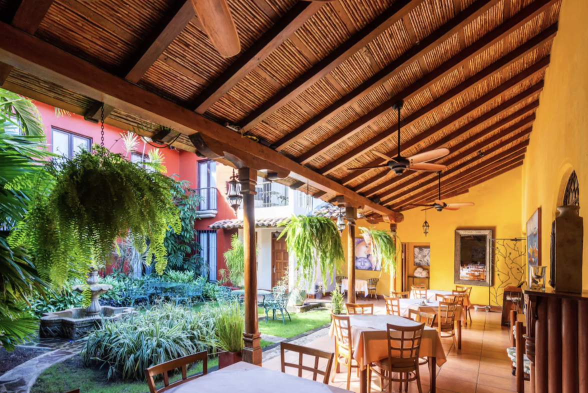 The outdoor seating area and lush courtyard of a hotel in Nicaragua