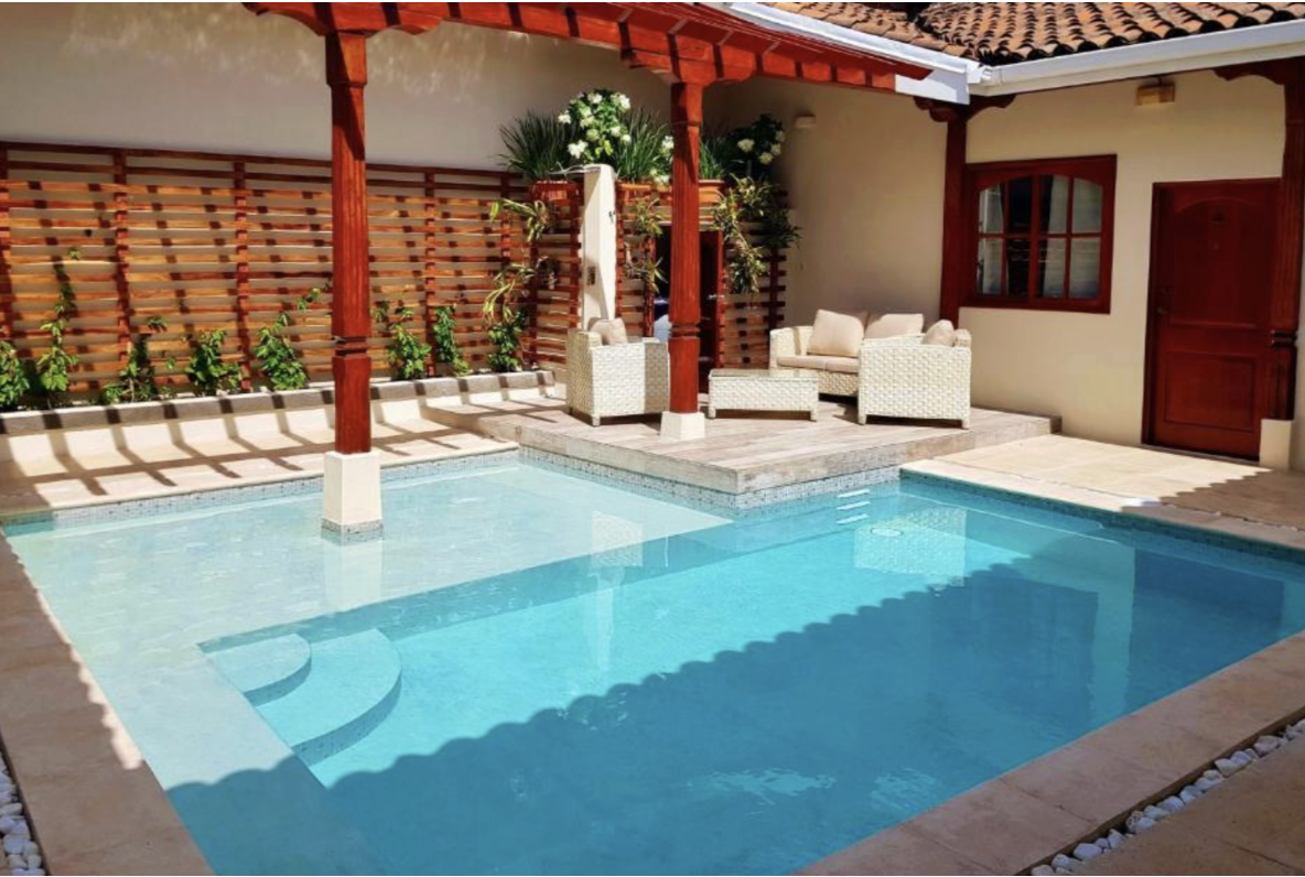 An outdoor pool and seating area at one of the best hotels in Nicaragua