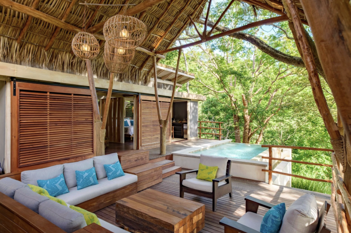 An elaborate outdoors seating area with a pool in a jungle setting at one of the best places to stay in Nicaragua 