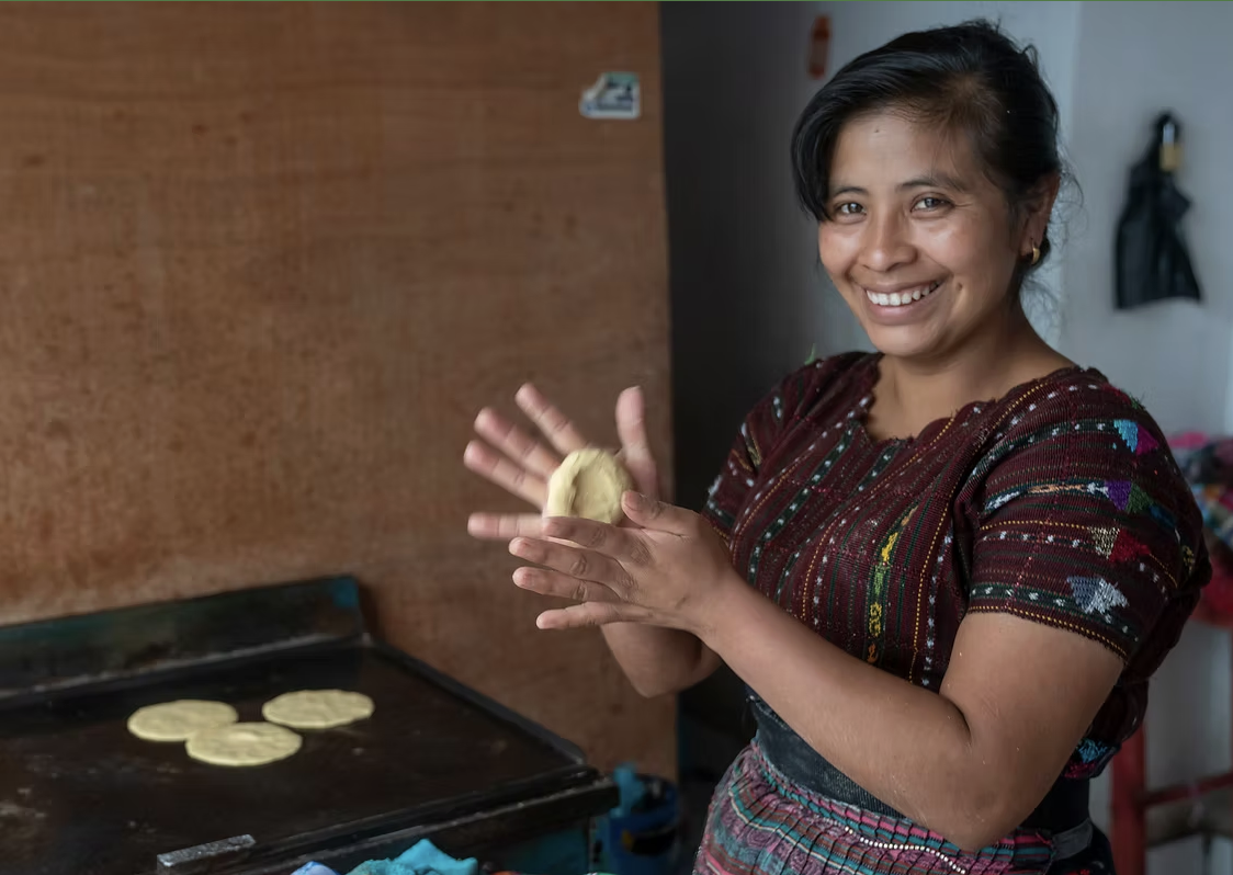 A woman is making tortillas by hand in Guatemala