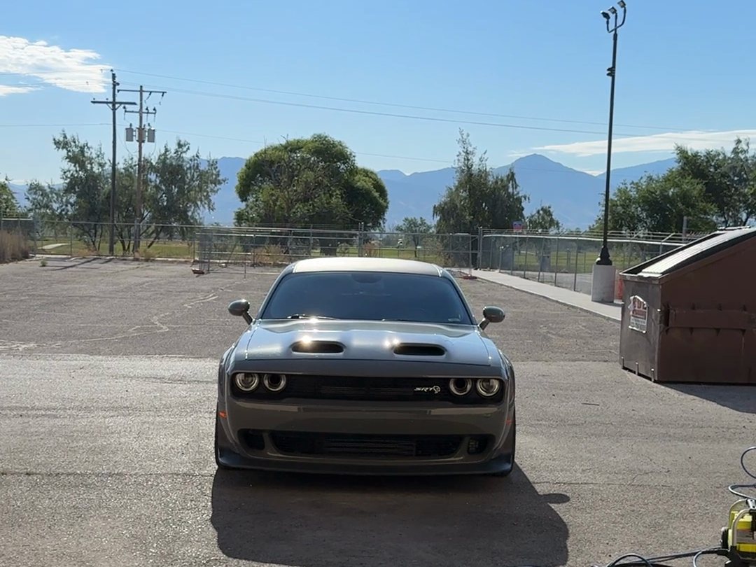 Coated Dodge Challenger SRT with the Wasatch mountains behind it