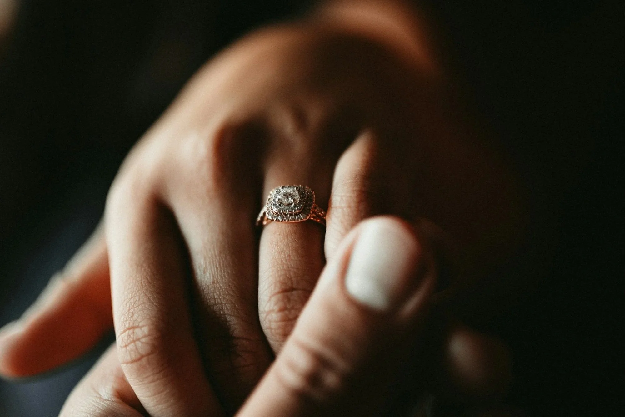 Hands joined, one wearing a ring