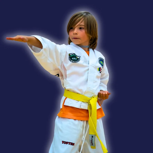 Young Taekwon-Do student in a yellow belt practising a focused technique in Lusk