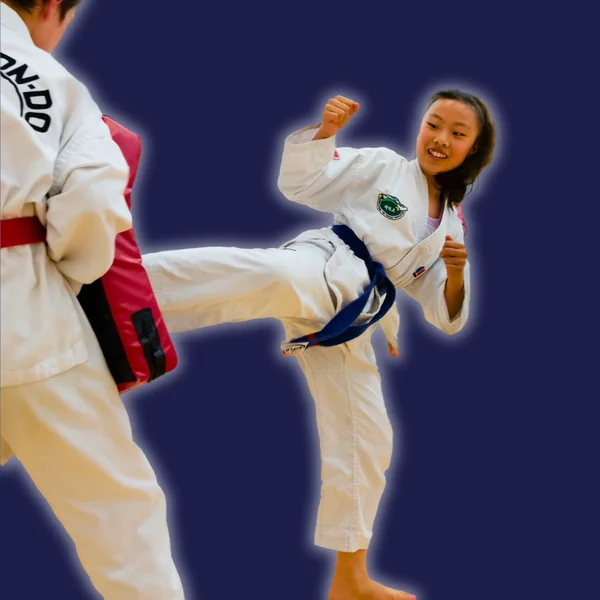 Smiling girl practising a Taekwon-Do kick at Elite Taekwon-Do Academy