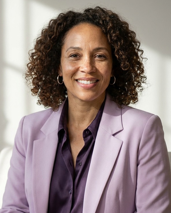 Smiling Afro-Latina professional woman in a soft lilac suit