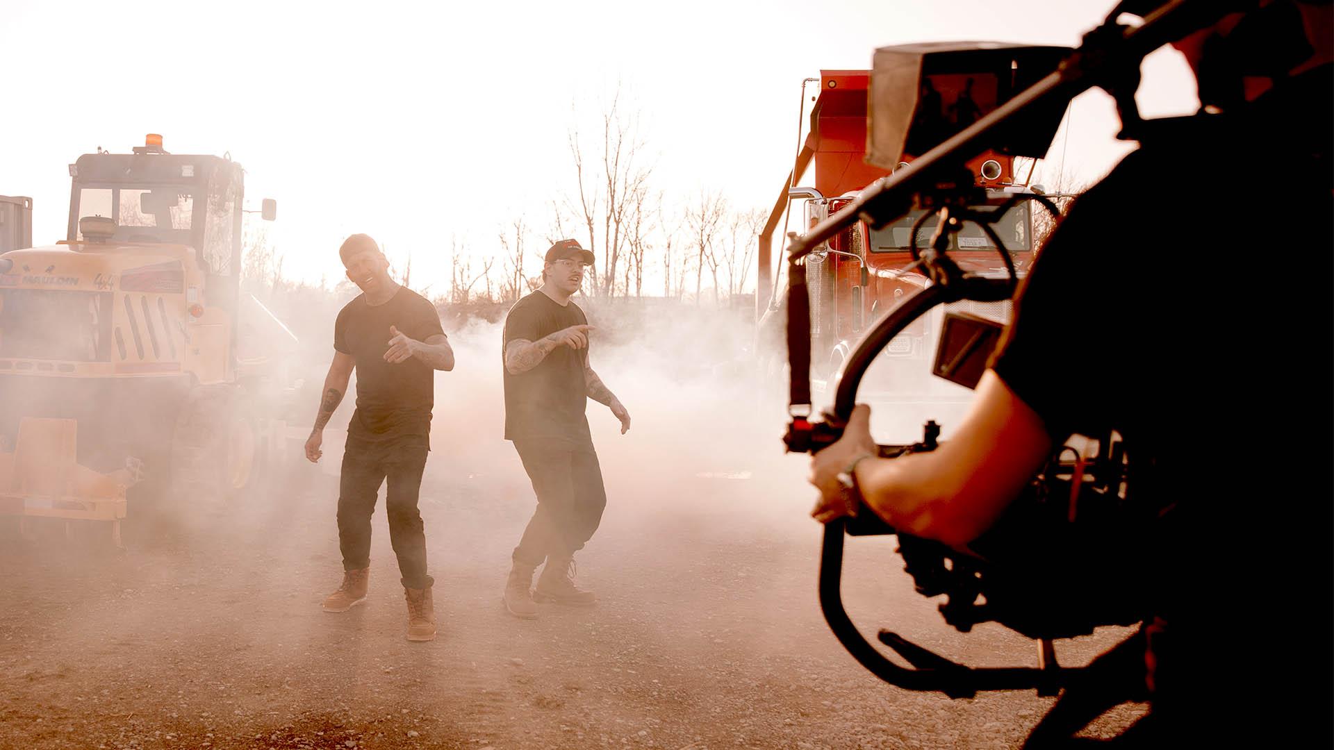 Football players walking through smoke in the Home Team music video