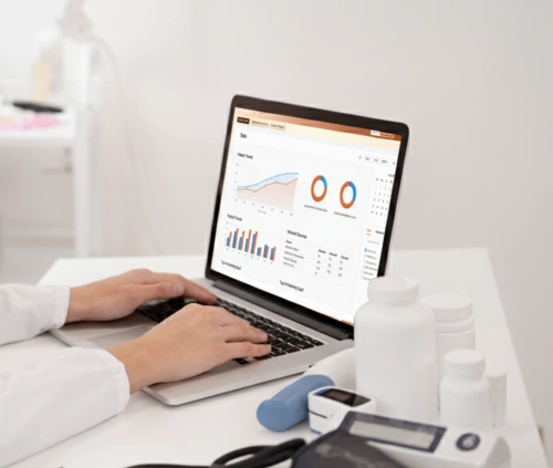 Laptop screen displaying Patient Lead Flow analytics and lead tracking dashboard