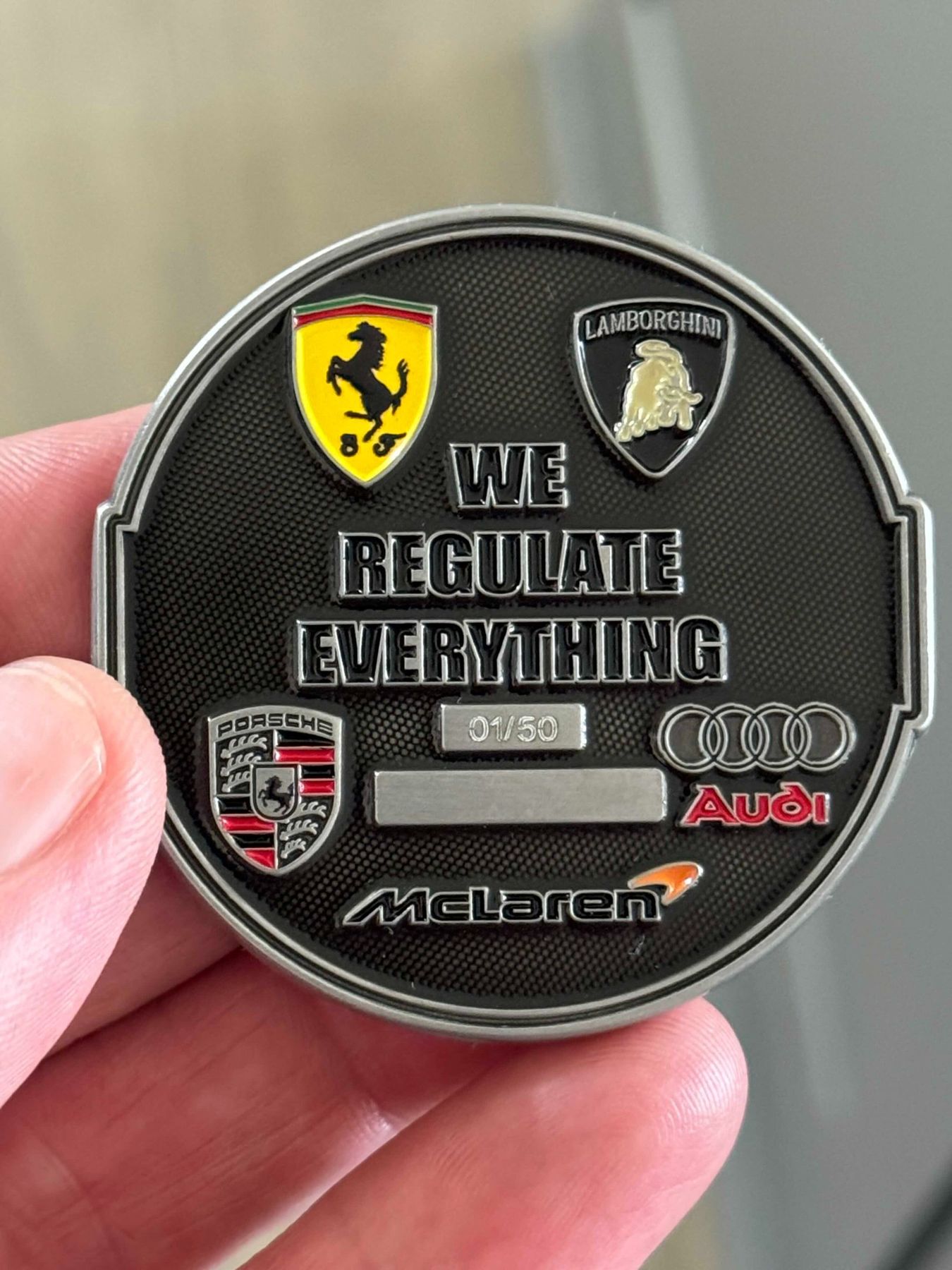 Back of the Regulators Car Club challenge coin: We Regulate Everything