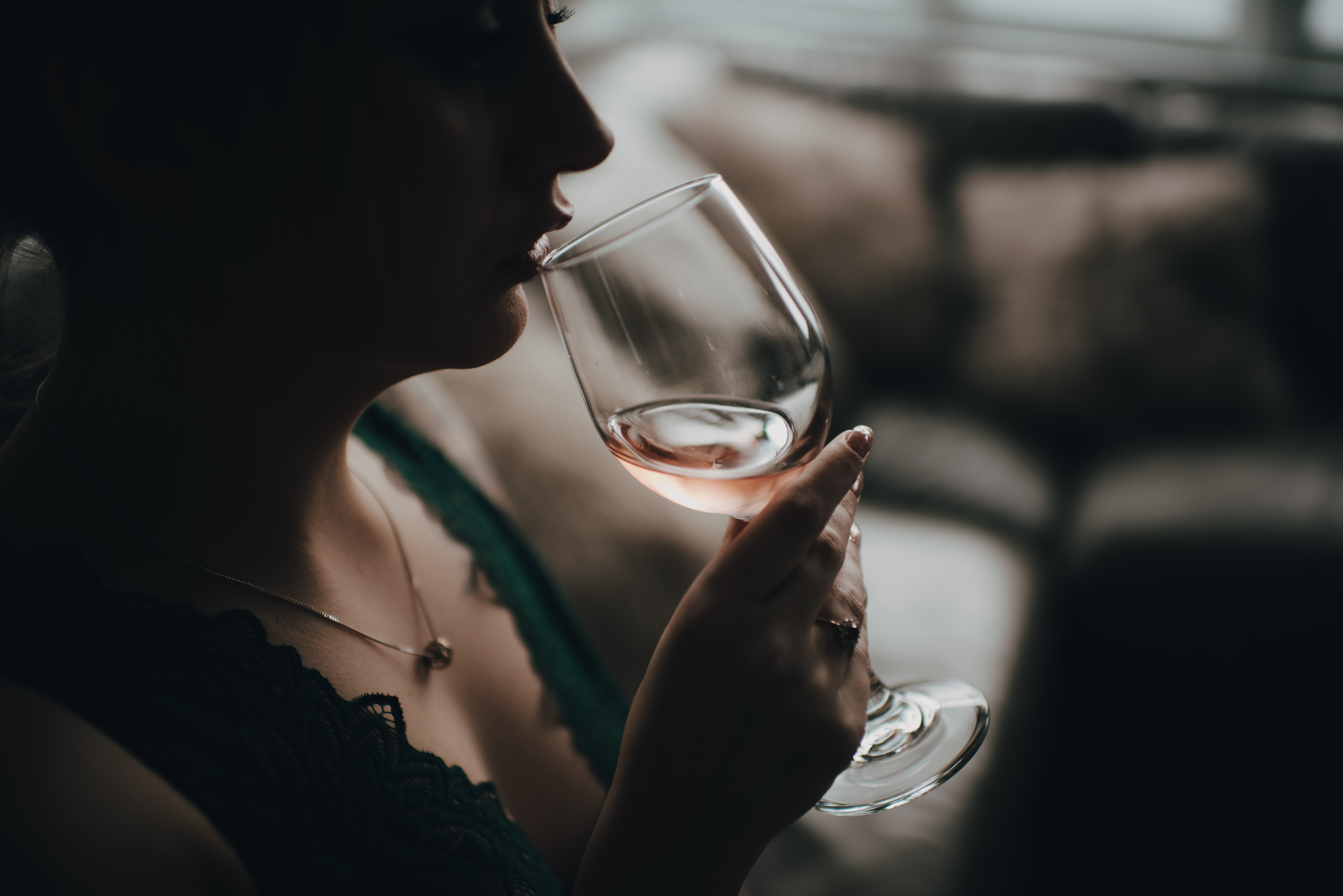 model sipping a glass of wine during their photoshoot