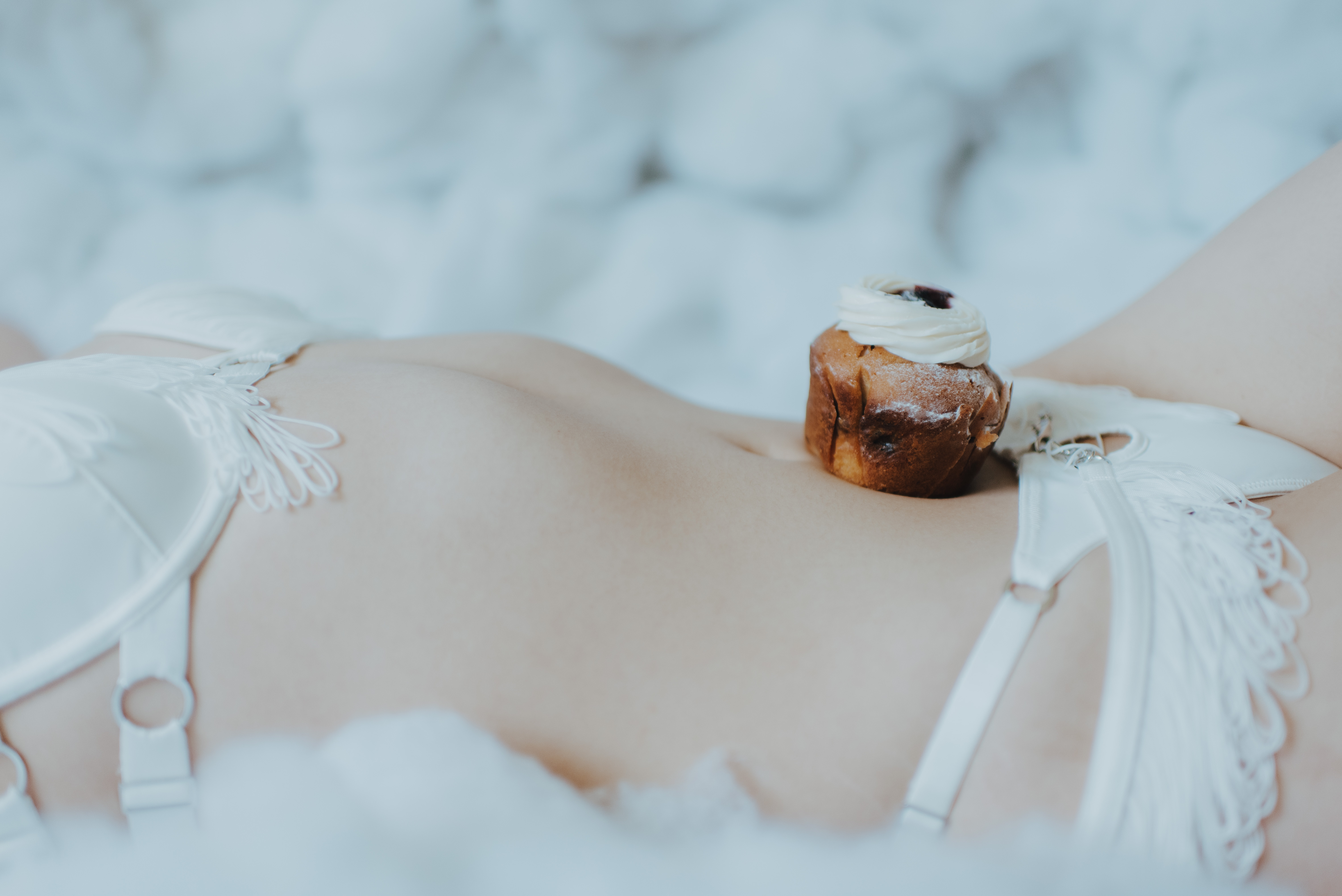 cupcake on person's belly for lingerie photoshoot