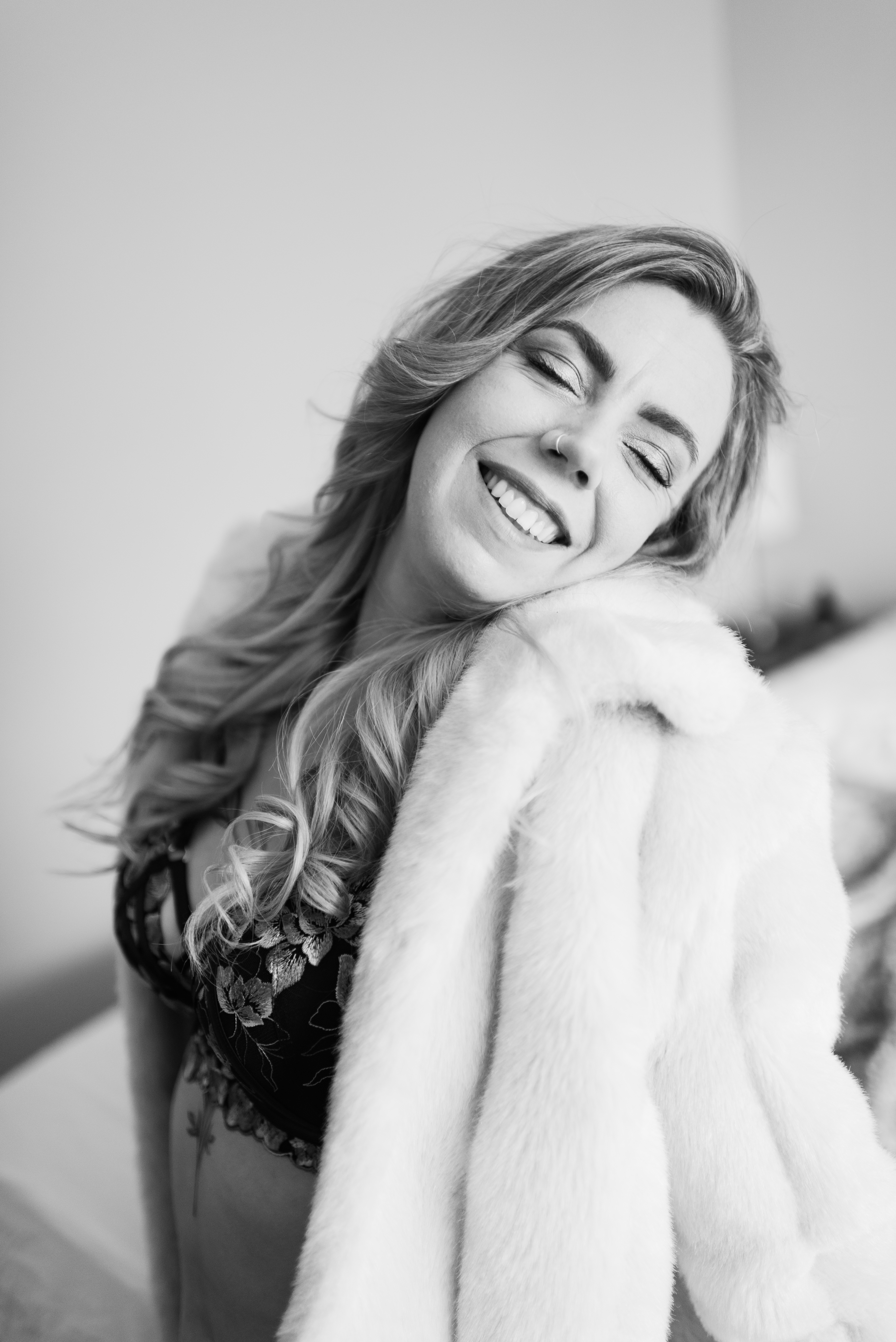 woman smiling while posing for camera in faux fur coat woman smiling while posing for camera in faux fur coat