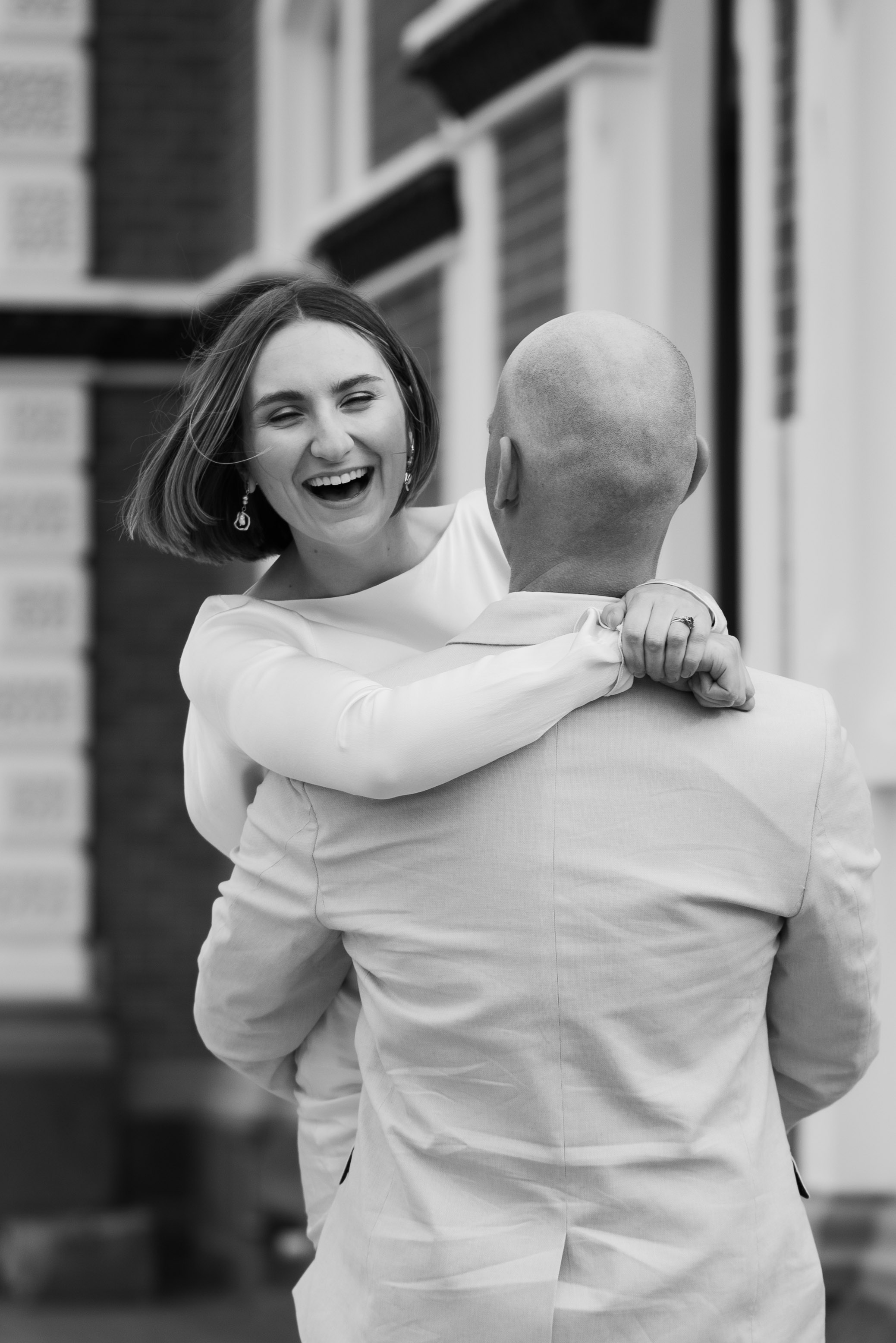 newlyweds laughing and dancing in cathedral square