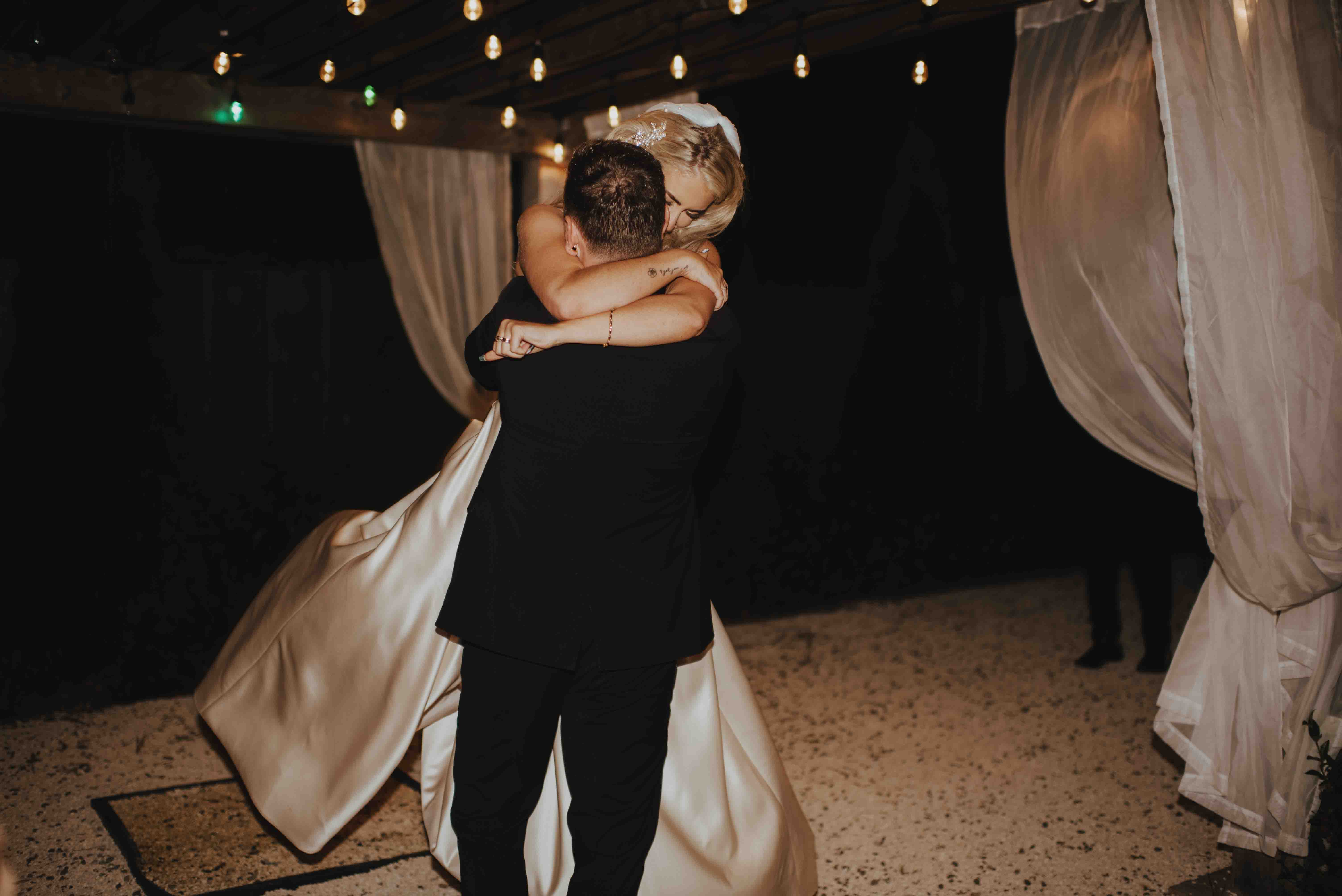 bride being swung around on the dancefloor by her new husband