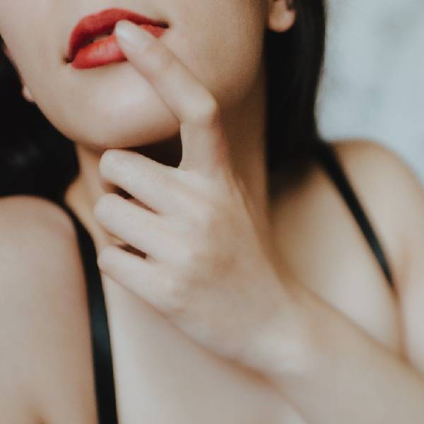 close up of woman biting her finger close up of woman biting her finger