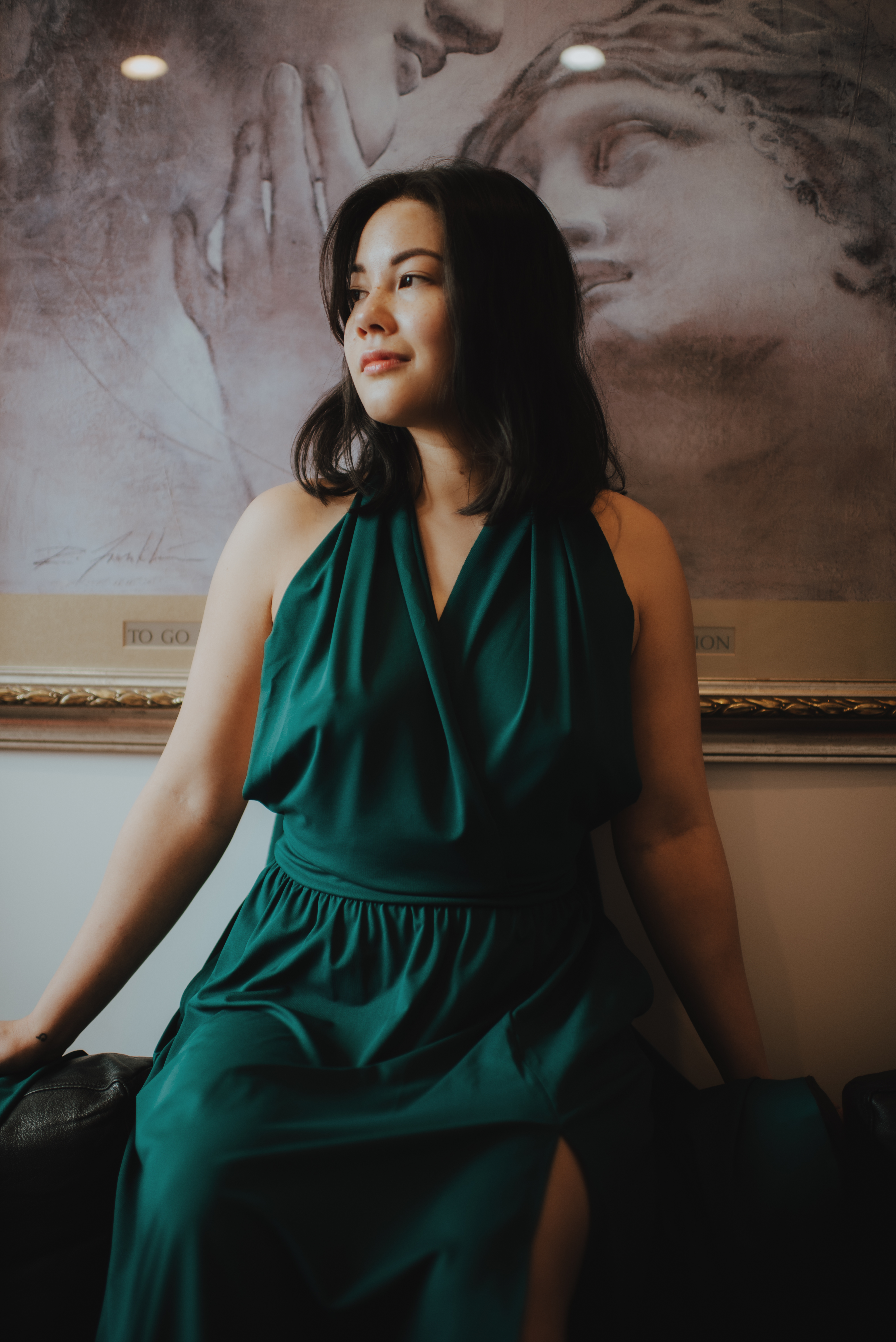 woman sitting on back of couch looking out of window