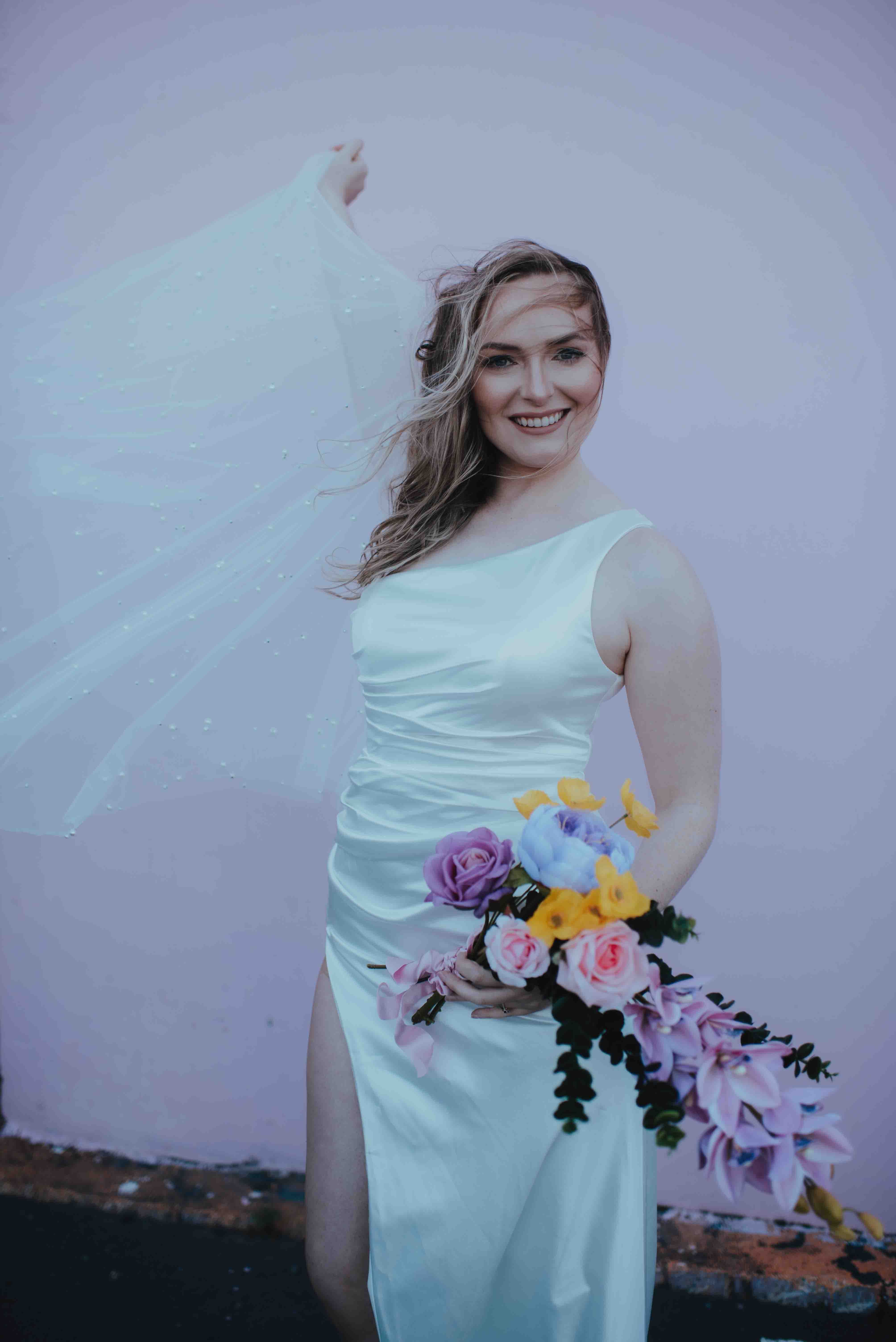 bride in front of pink pastel graffiti wall