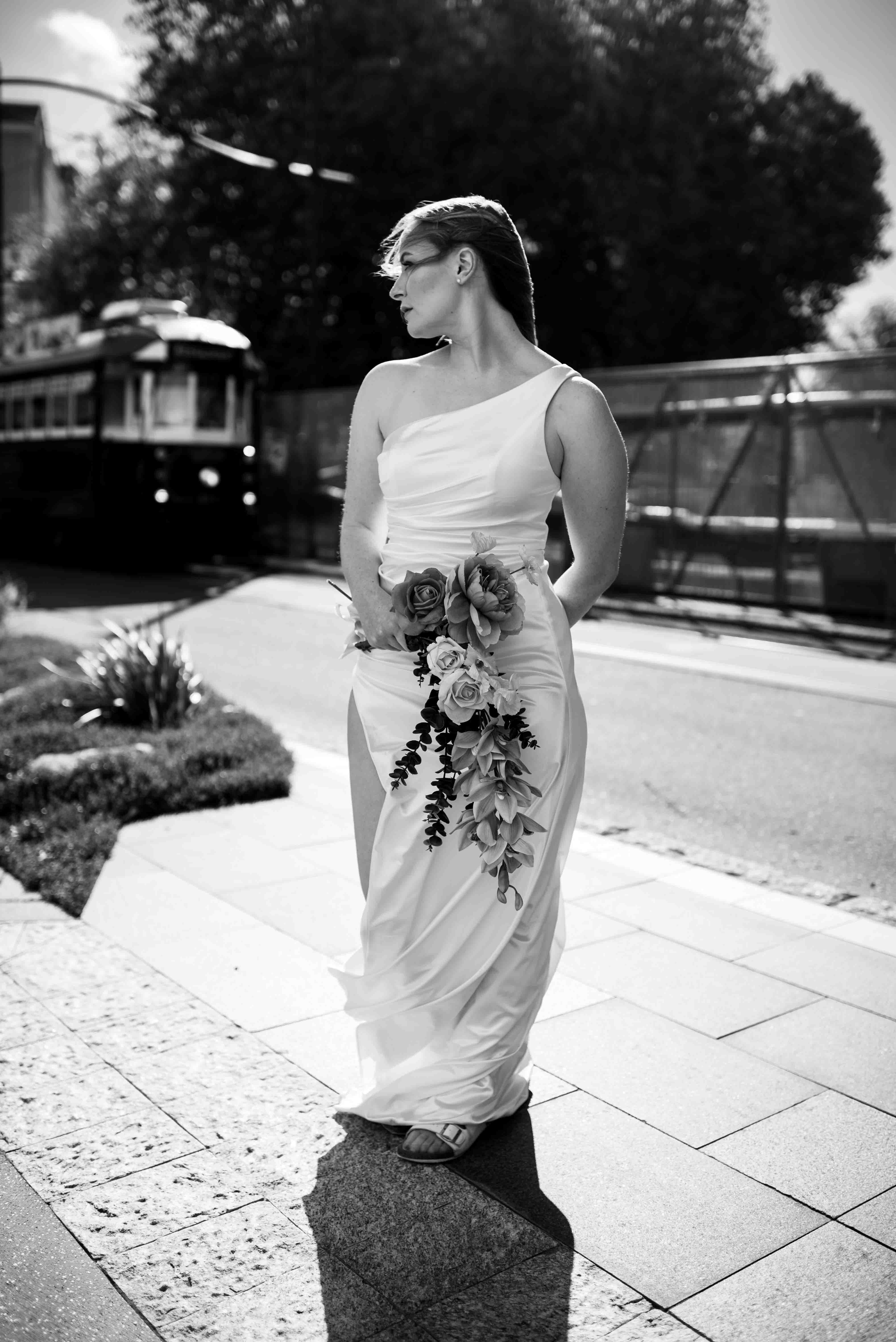 tram passing behind bride