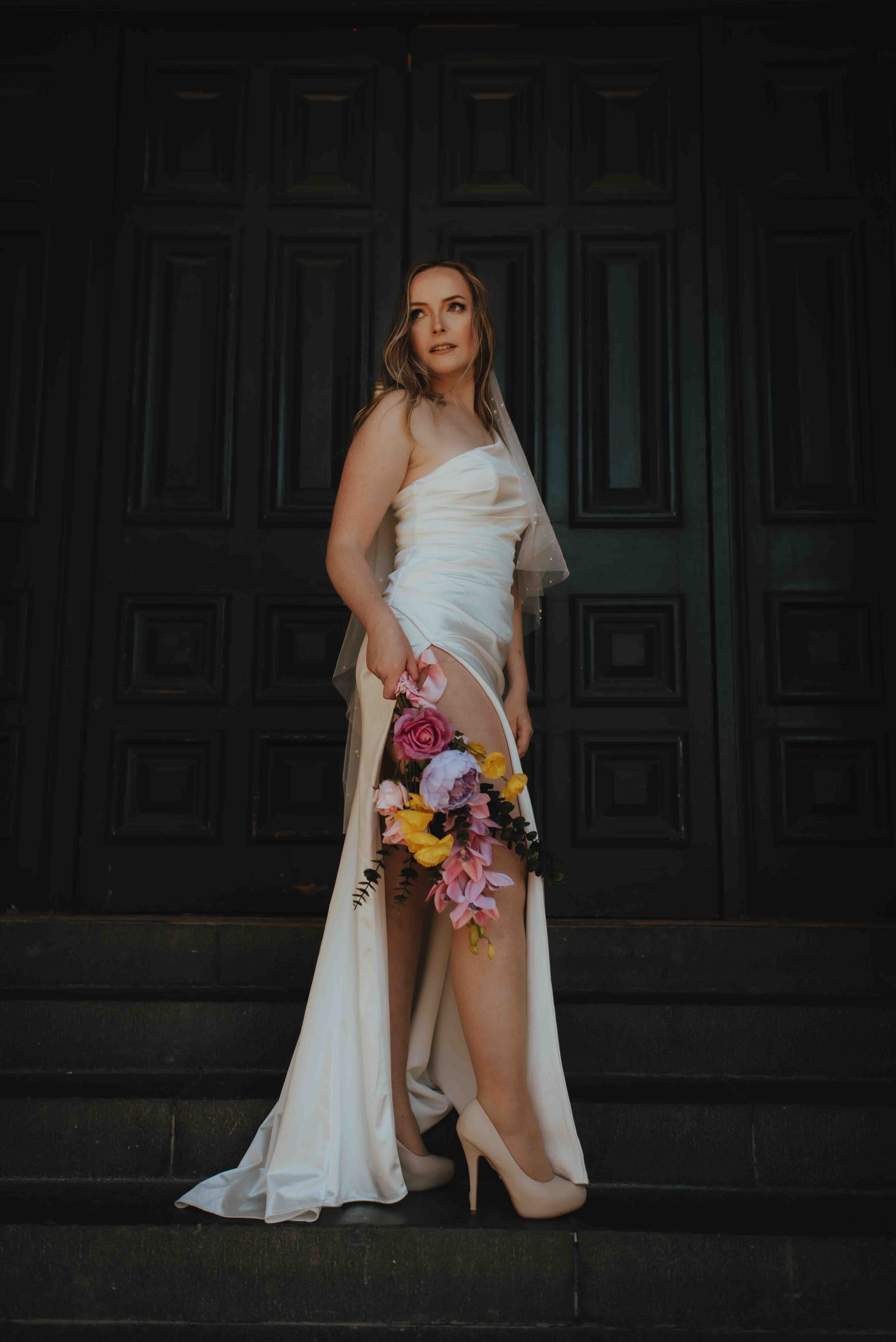 bride standing on steps at side door of o.g.b