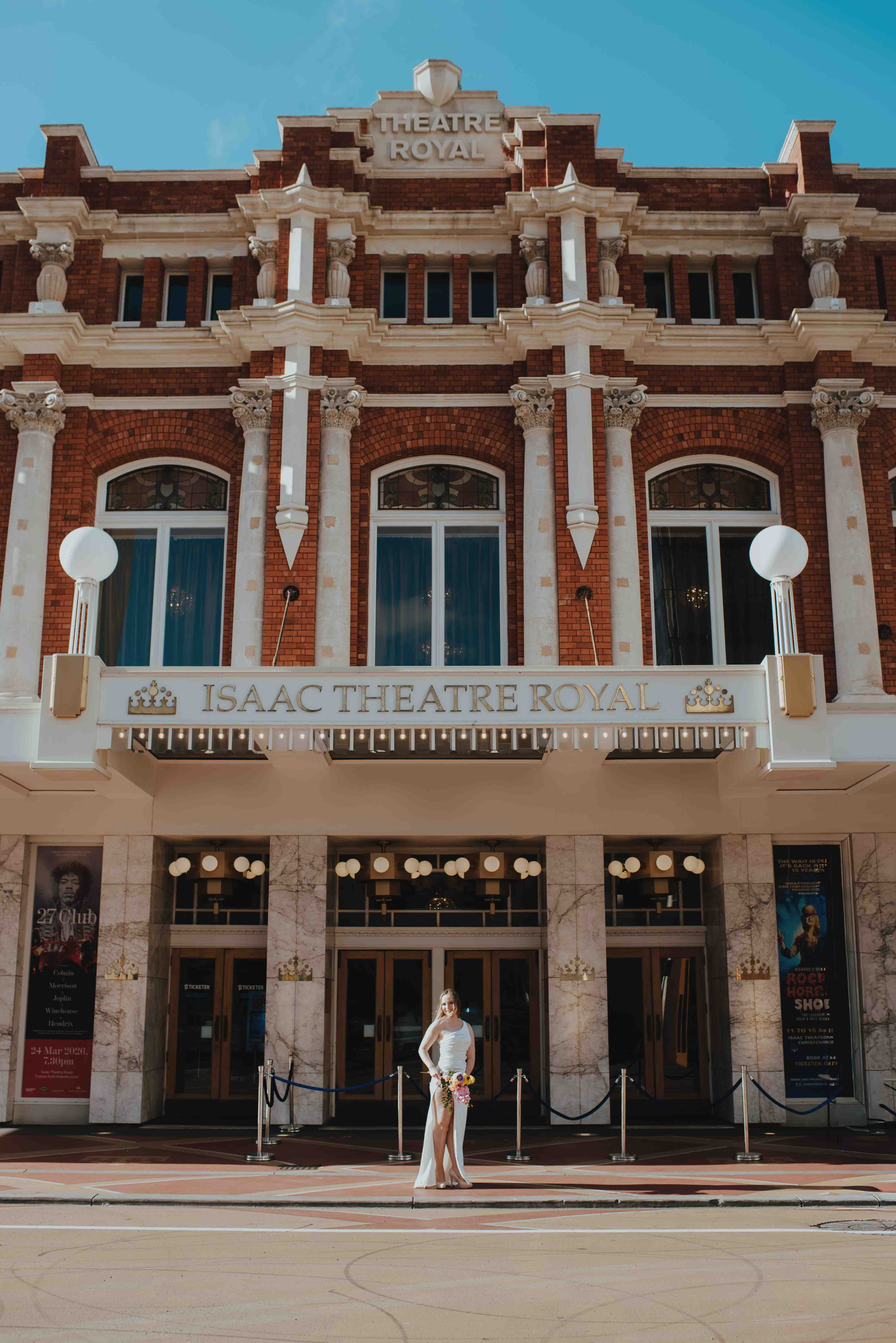 bride posing for photos in front of isaac theatre royal