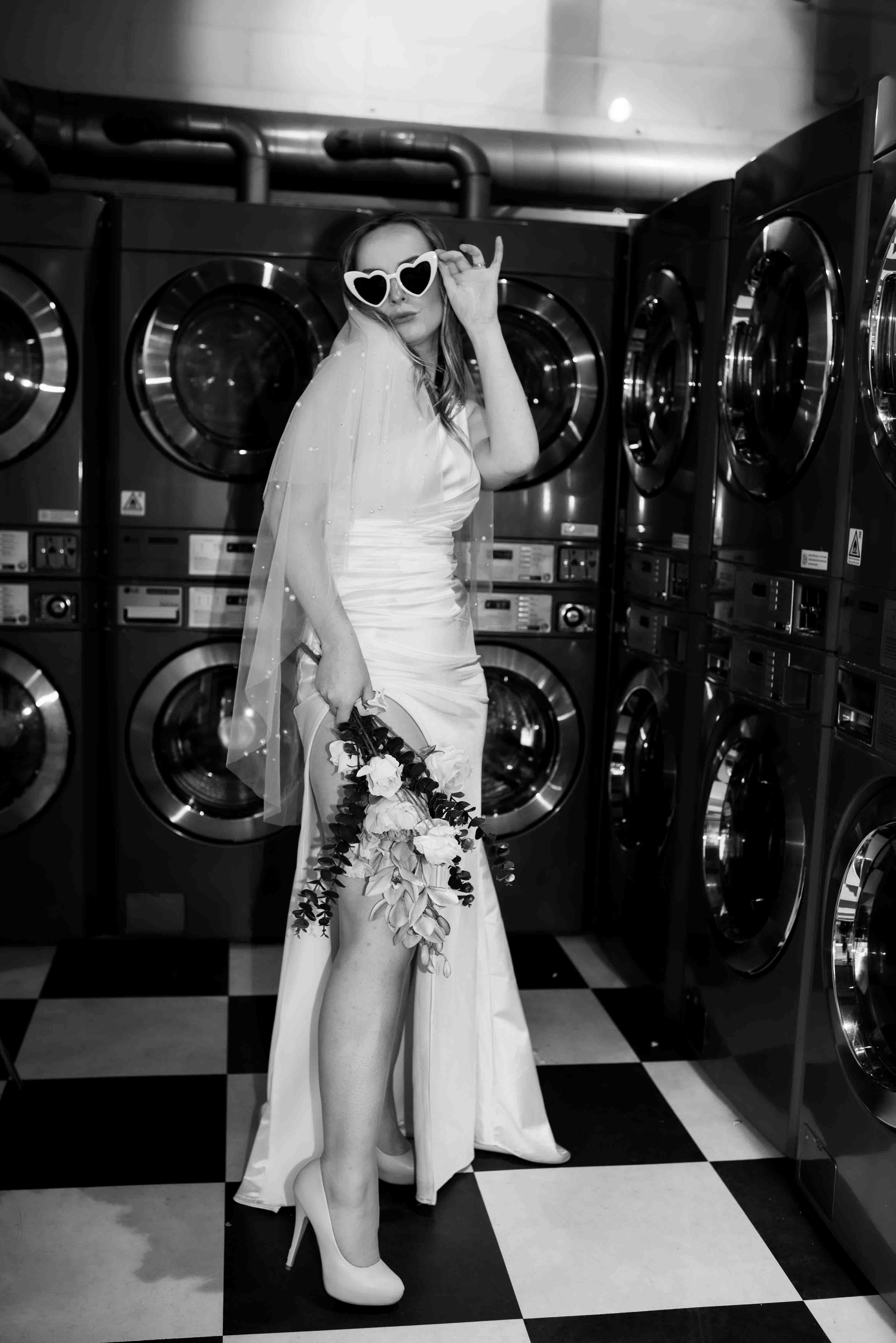 bride posing with laughter in laundromat