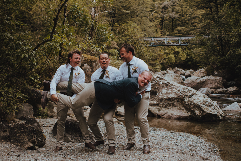 groomsmen having a laugh with a funny pose during bridal party photos