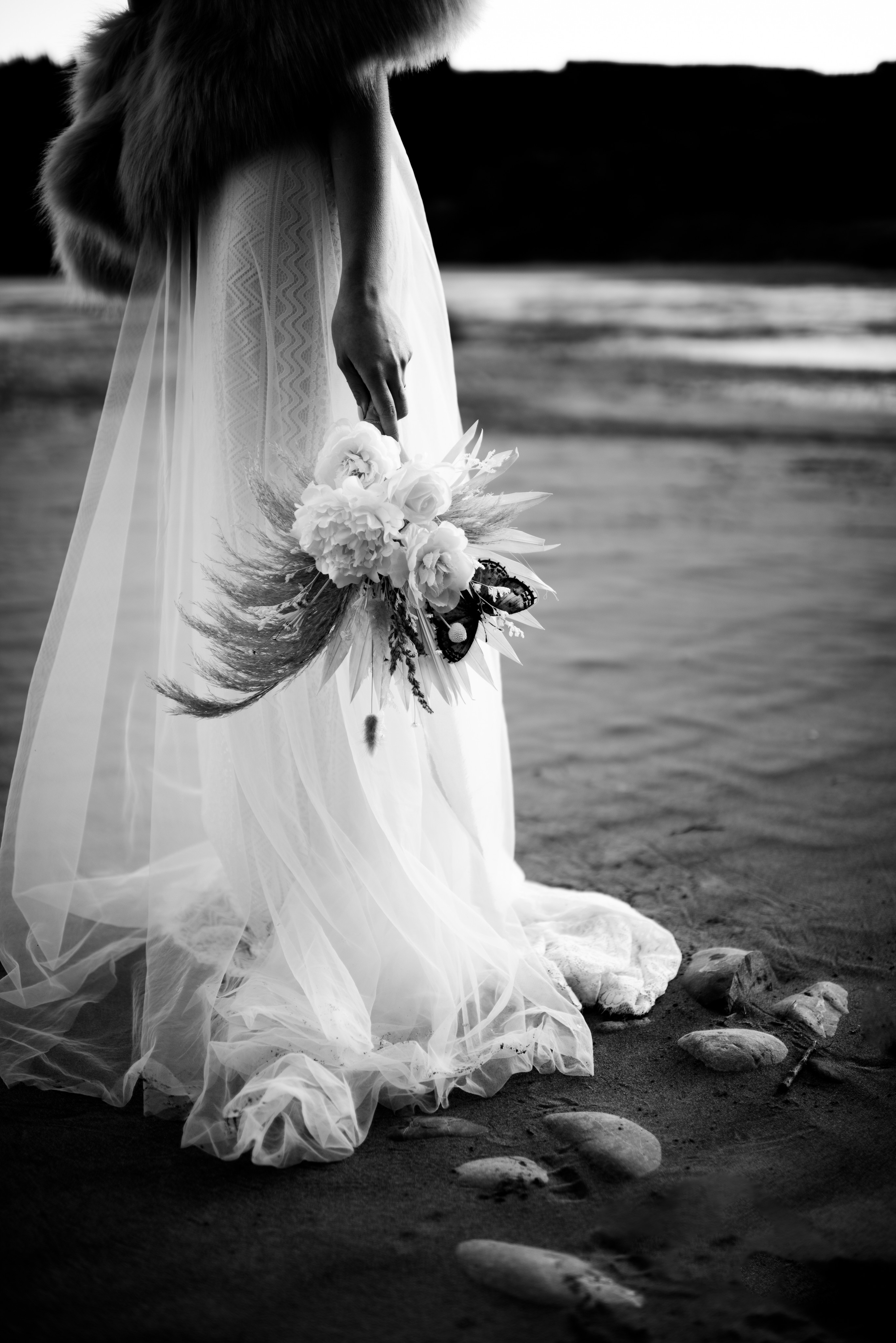 bottom detailing of skirt layers on wedding dress on river bank