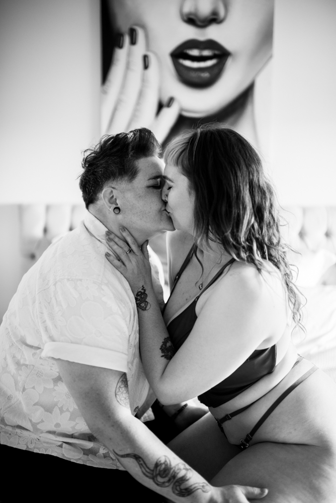 queer gender fluid couple kissing on bed