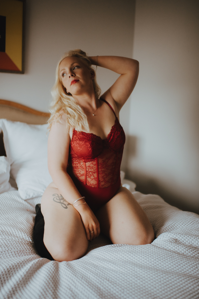 boudoir model posing with hands in her hair boudoir model posing with hands in her hair