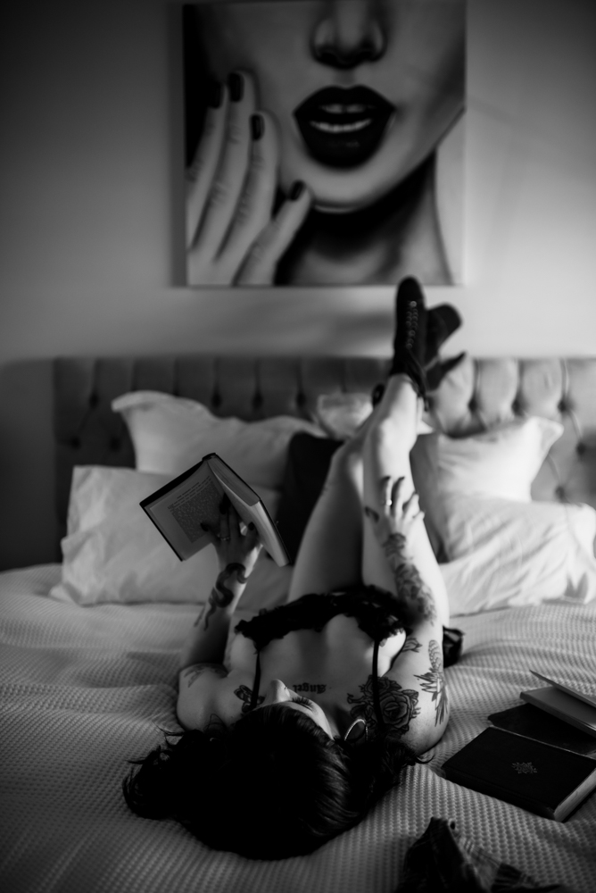 lying on back on bed reading a book lying on back on bed reading a book