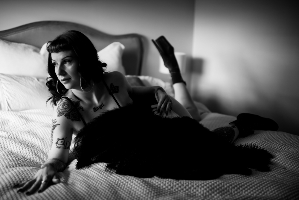 model lying on the bed fanning themselves with ostrich feather fans model lying on the bed fanning themselves with ostrich feather fans