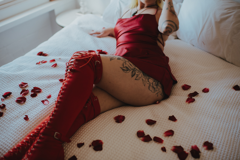 person wearing red dress for lingerie type shoot 