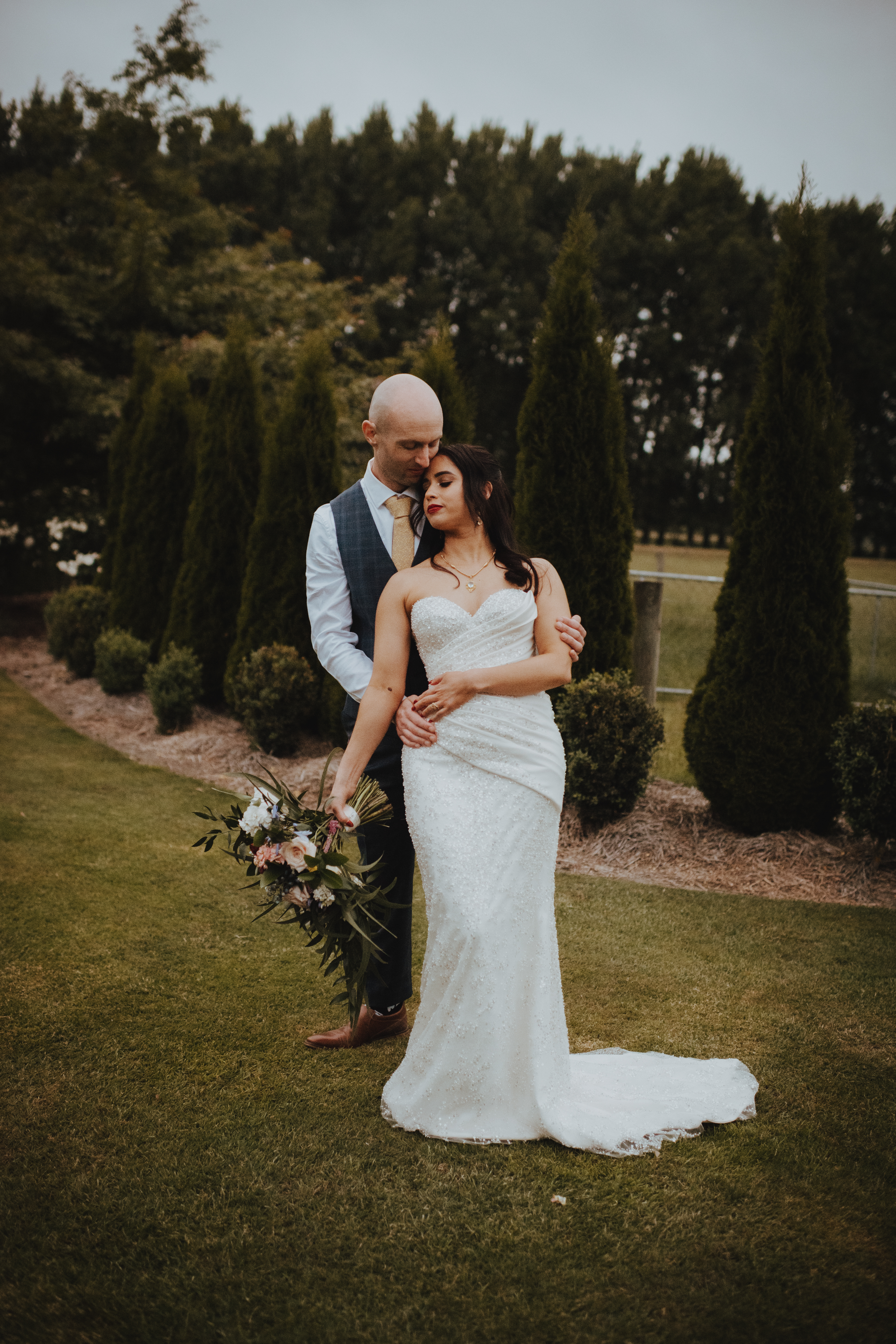 newlyweds cuddling under a setting sun at Lacebark wedding venue newlyweds cuddling under a setting sun at Lacebark wedding venue