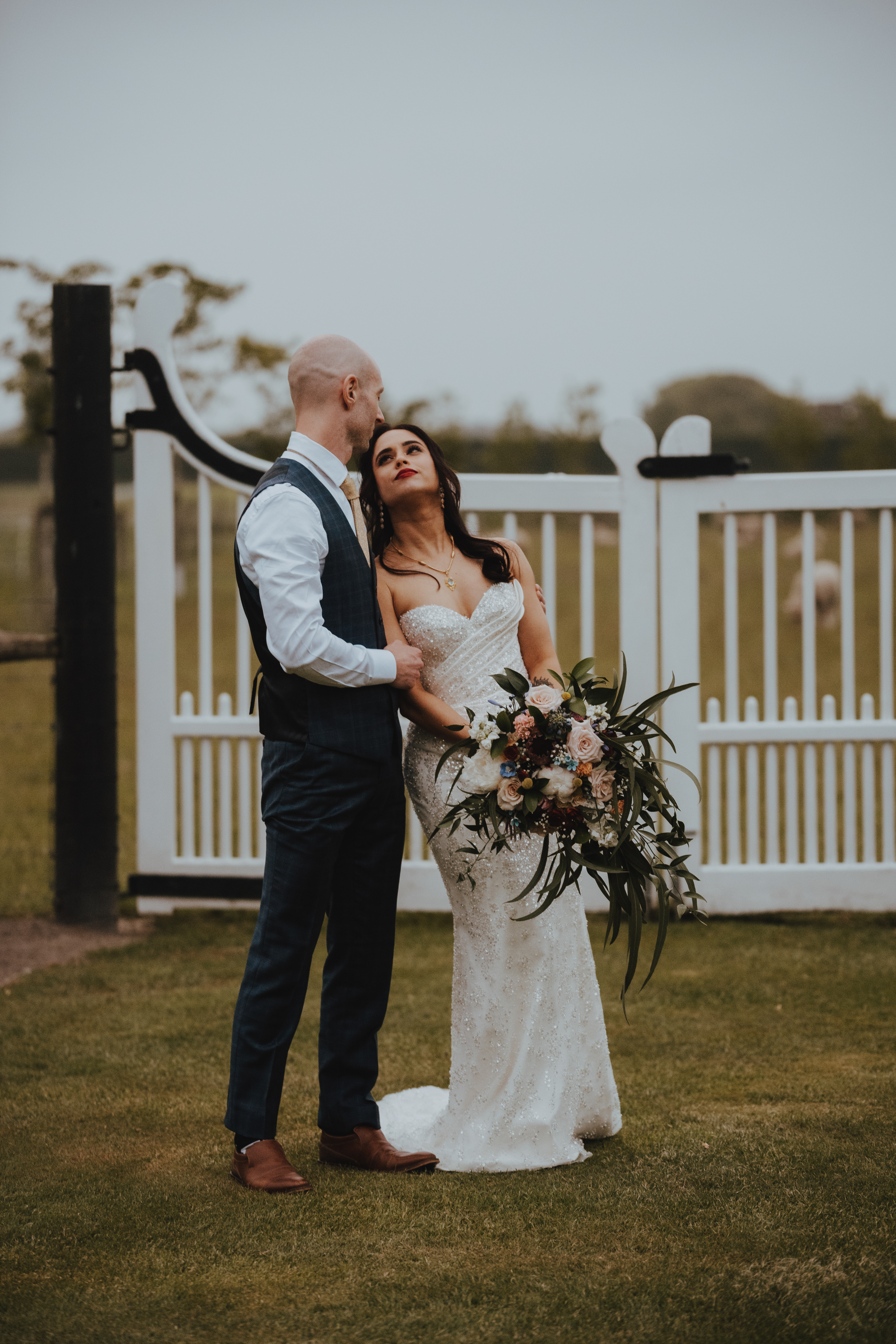 newlyweds cuddling up under a dark sunset newlyweds cuddling up under a dark sunset