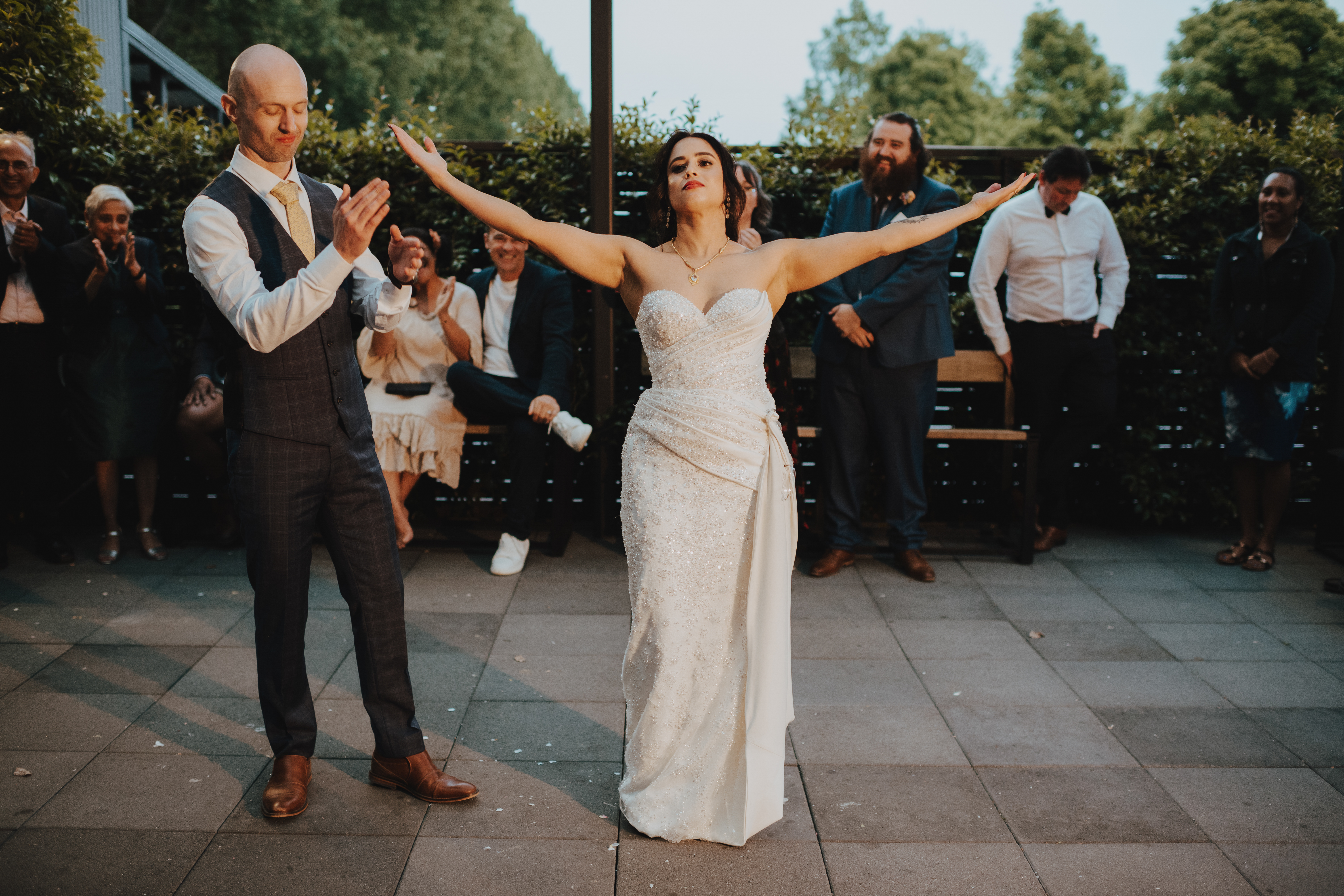bride taking a bow while her groom claps after the first dance bride taking a bow while her groom claps after the first dance