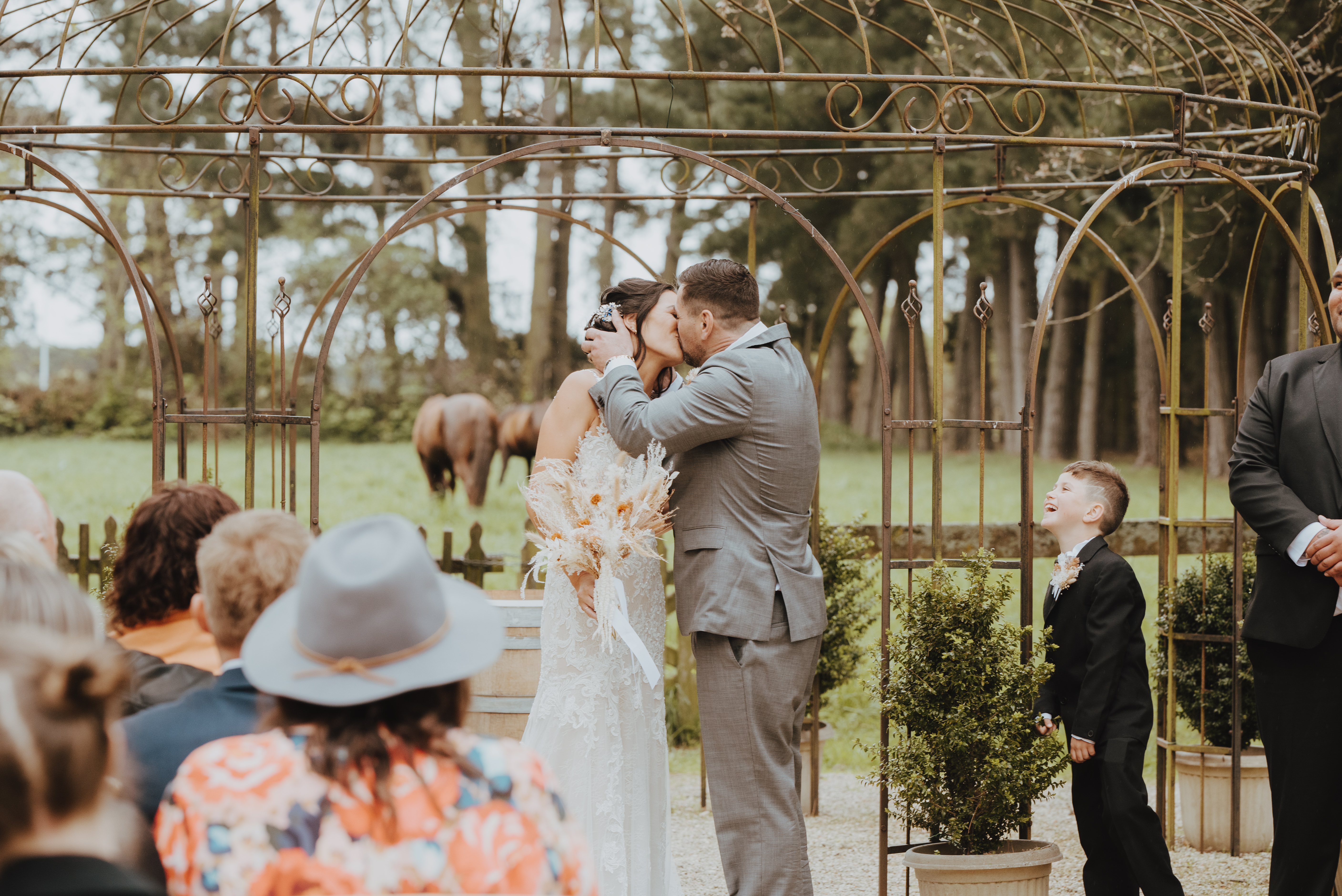 couple sharing first kiss during a Trents vineyard ceremony couple sharing first kiss during a Trents vineyard ceremony