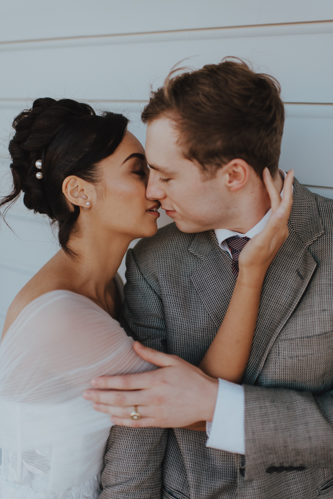 messy bridal bun on display for "almost kiss" newlywed pose messy bridal bun on display for "almost kiss" newlywed pose
