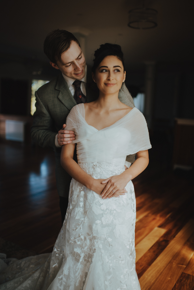 newlyweds basking in the glow of a stained glass window originally from Sainsbury House newlyweds basking in the glow of a stained glass window originally from Sainsbury House