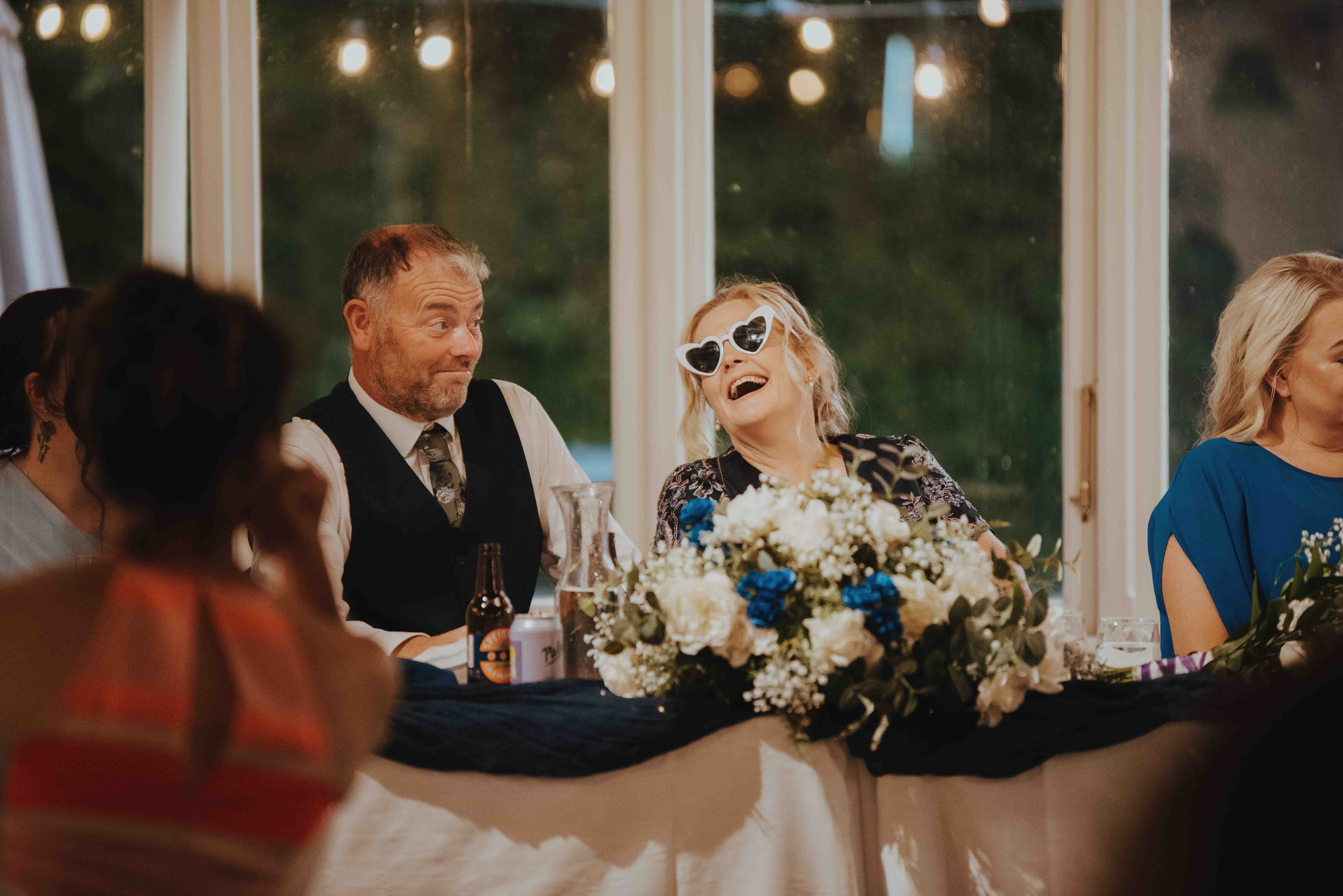 couple laughing during guest speeches