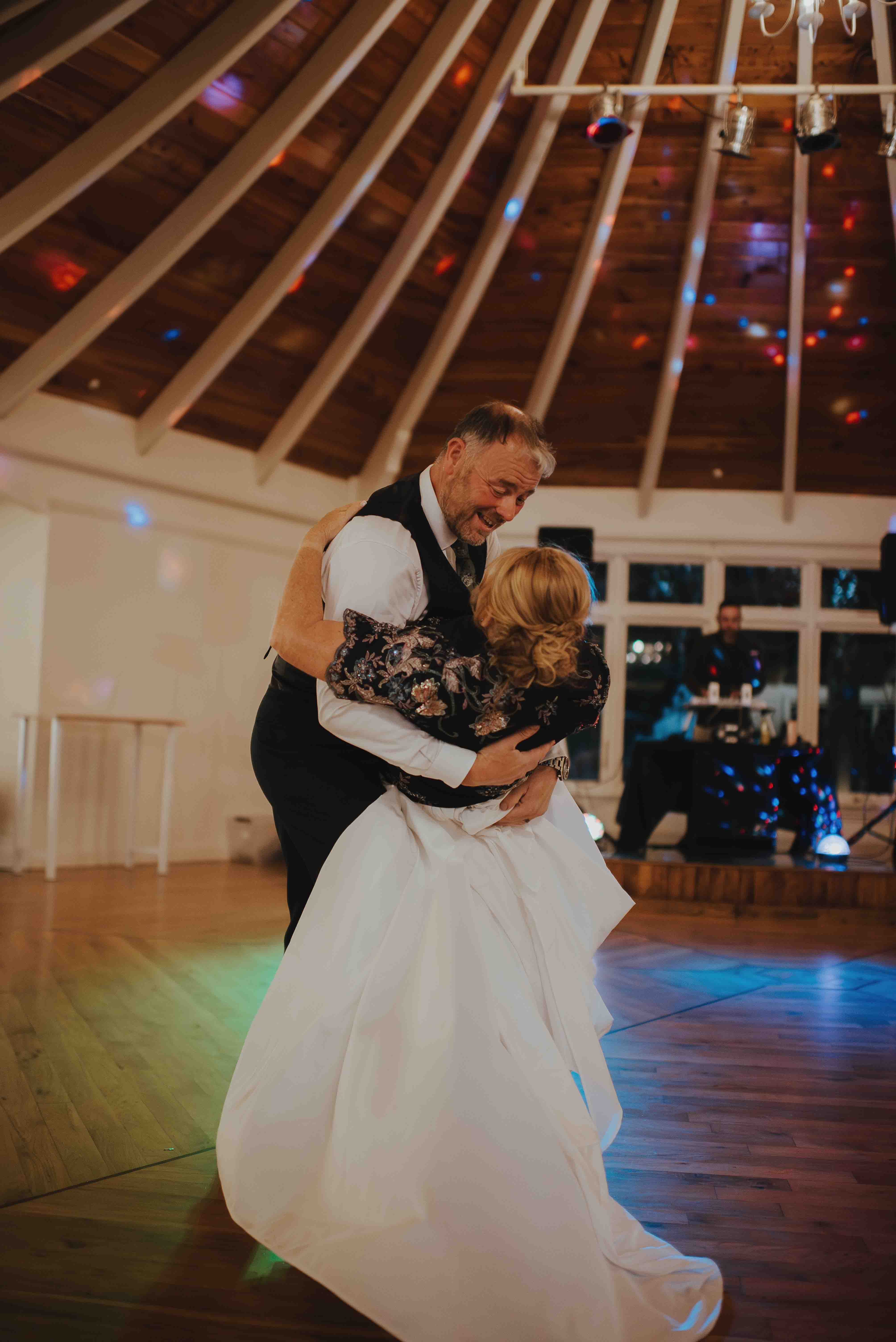 dipping his bride for a kiss during the first dance